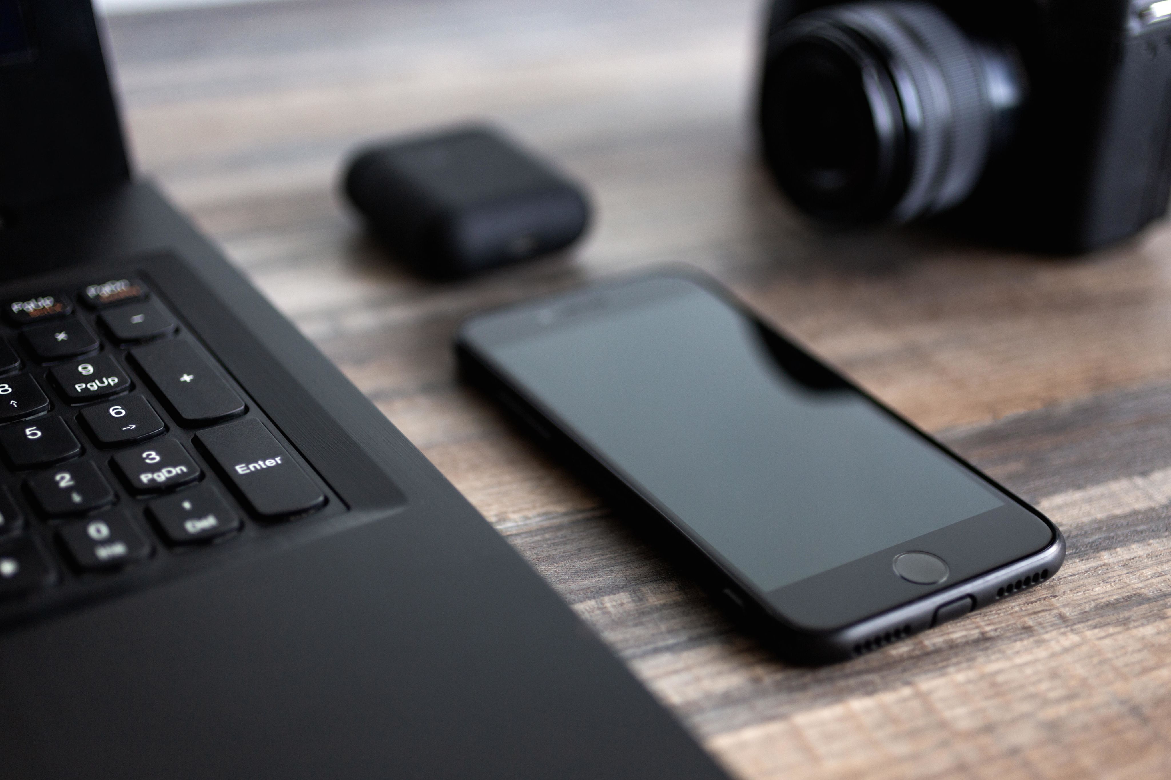 Close up on journalist's laptop and phone