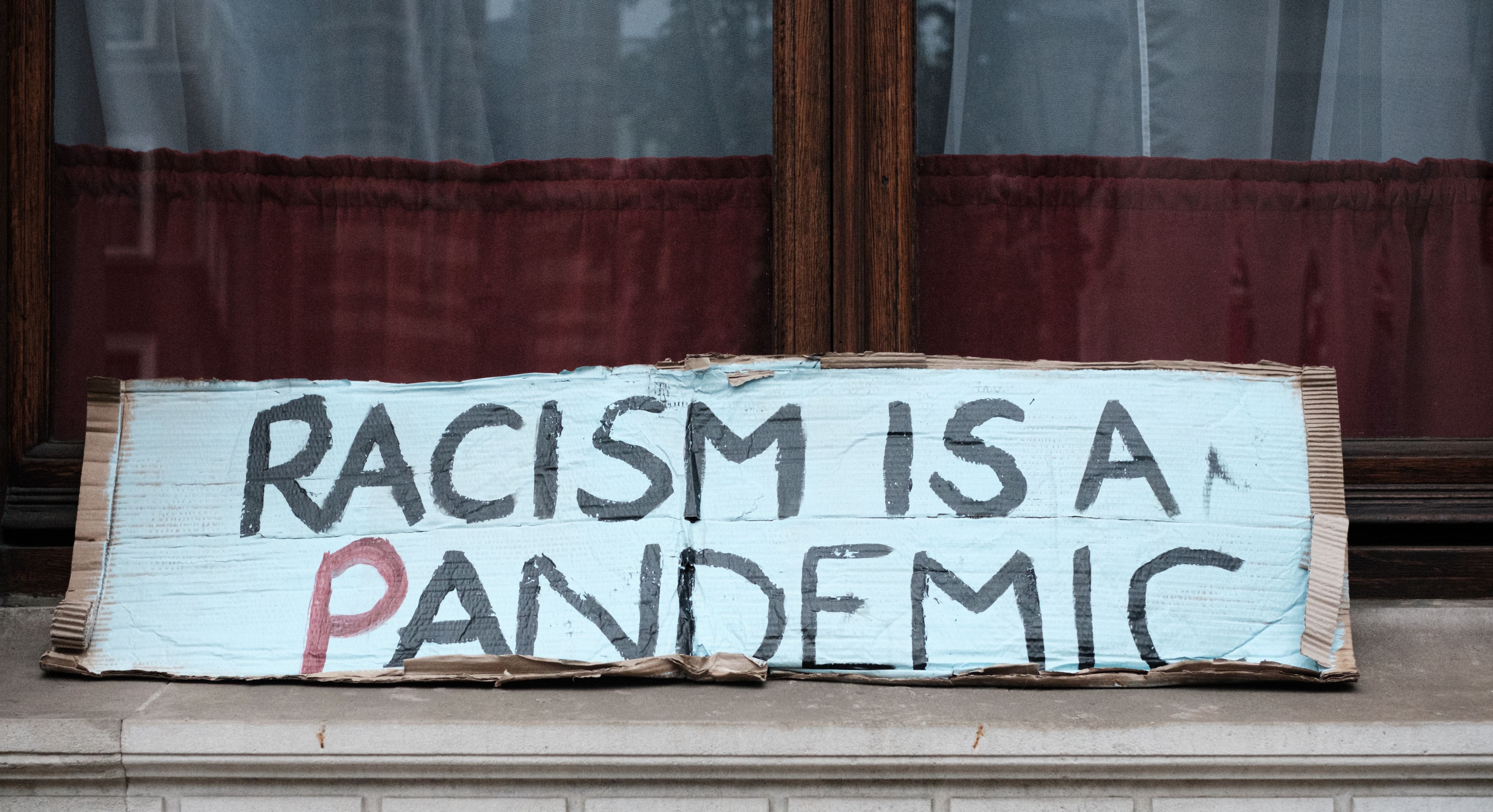 Homemade sign "Racism is a Pandemic"