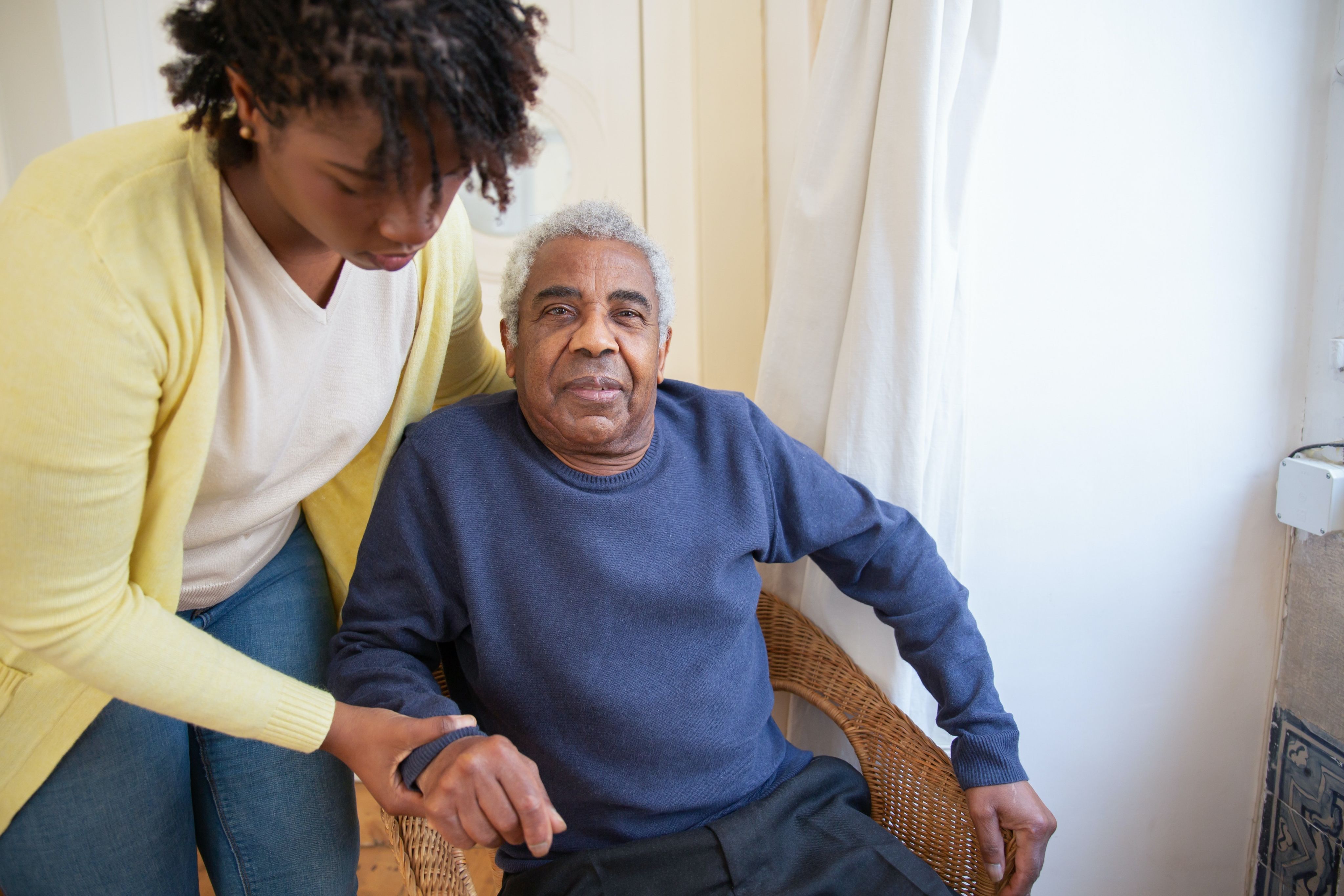 Woman assisting elderly man.