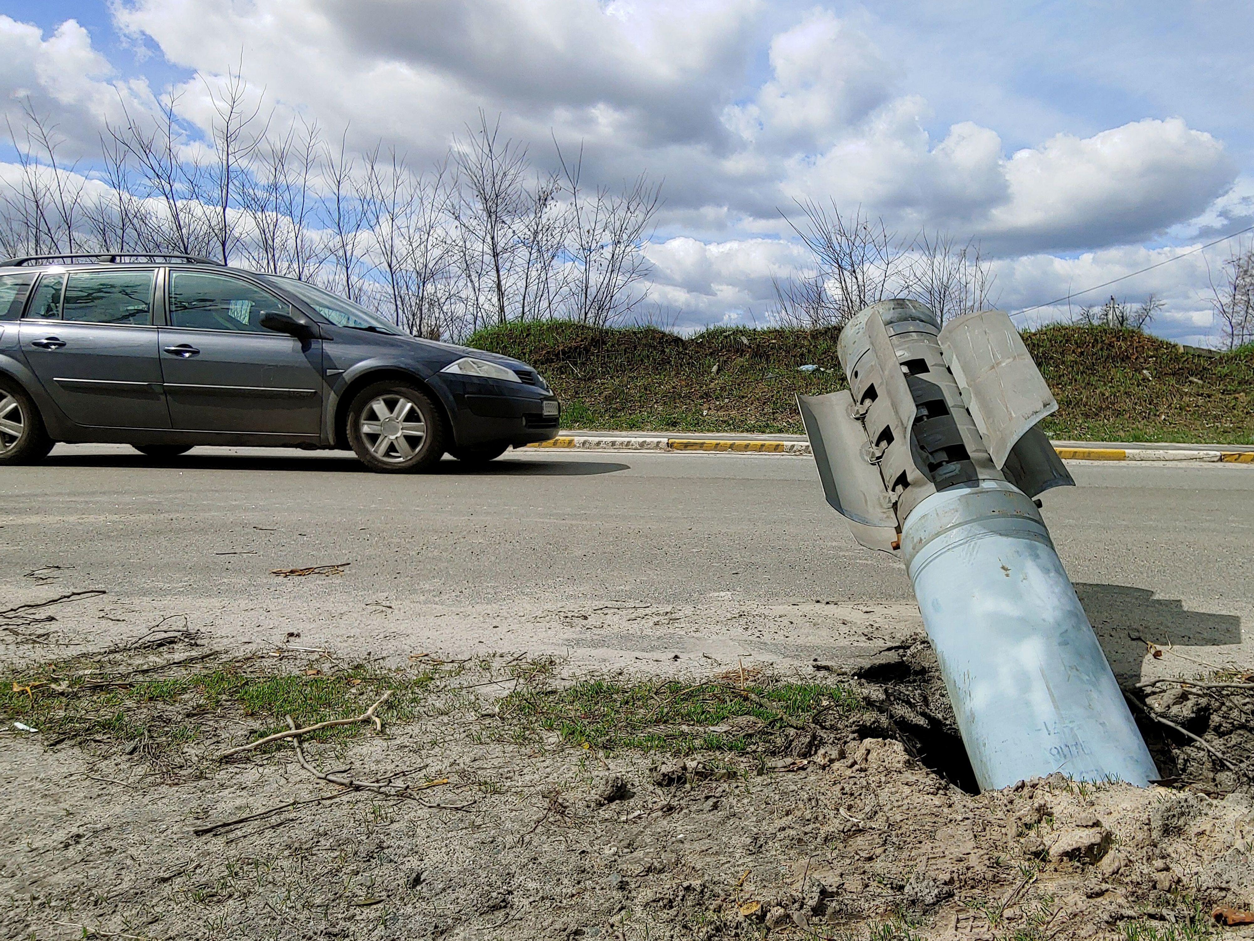 Unexploded russian missile sticking out at the roadway in Hostomel during Russian war in Ukraine in 2022