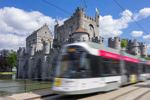 A blurred tram passing a castle in Ghent, Belgium