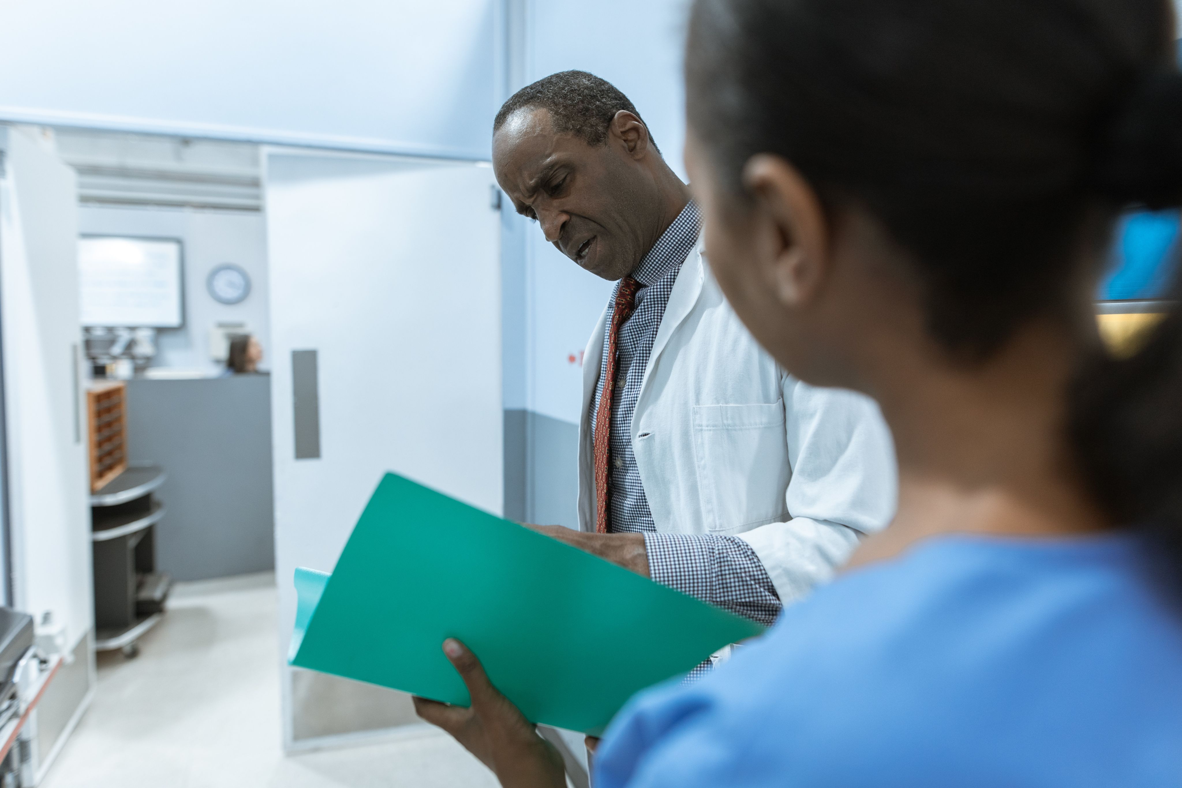 A photo of two healthcare professionals; both are people of color.
