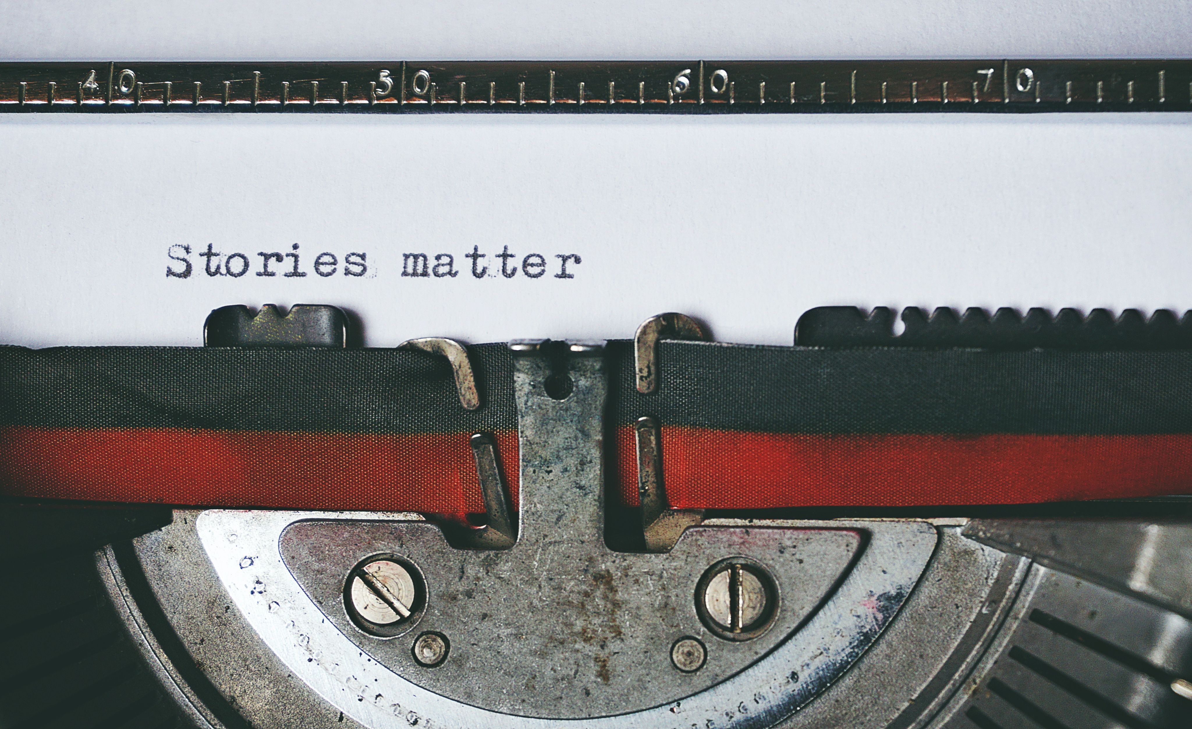 Old fashioned typewriter with "stories matter" typed onto white paper.