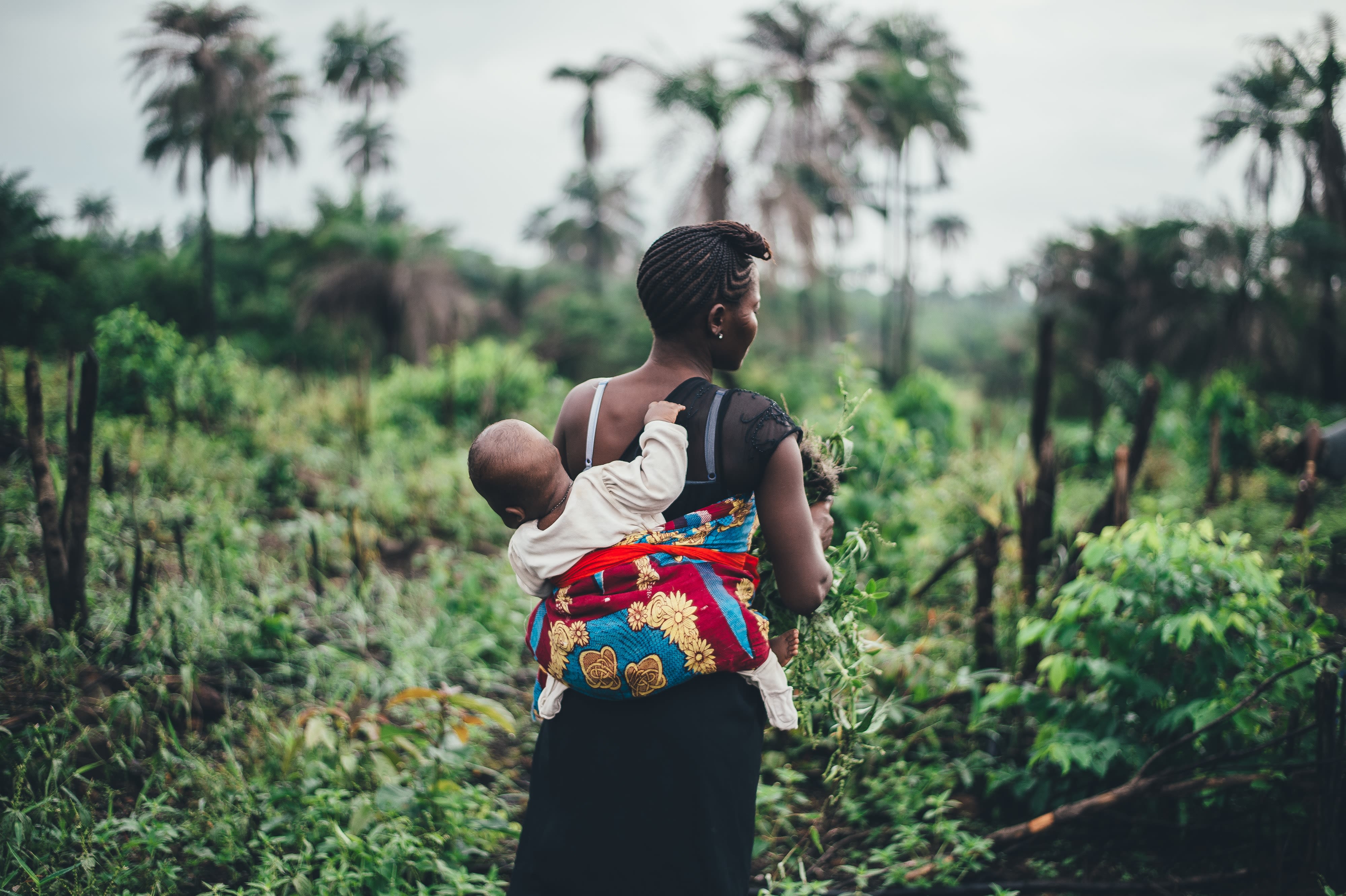 Mother and child in a field Sierra Leone.