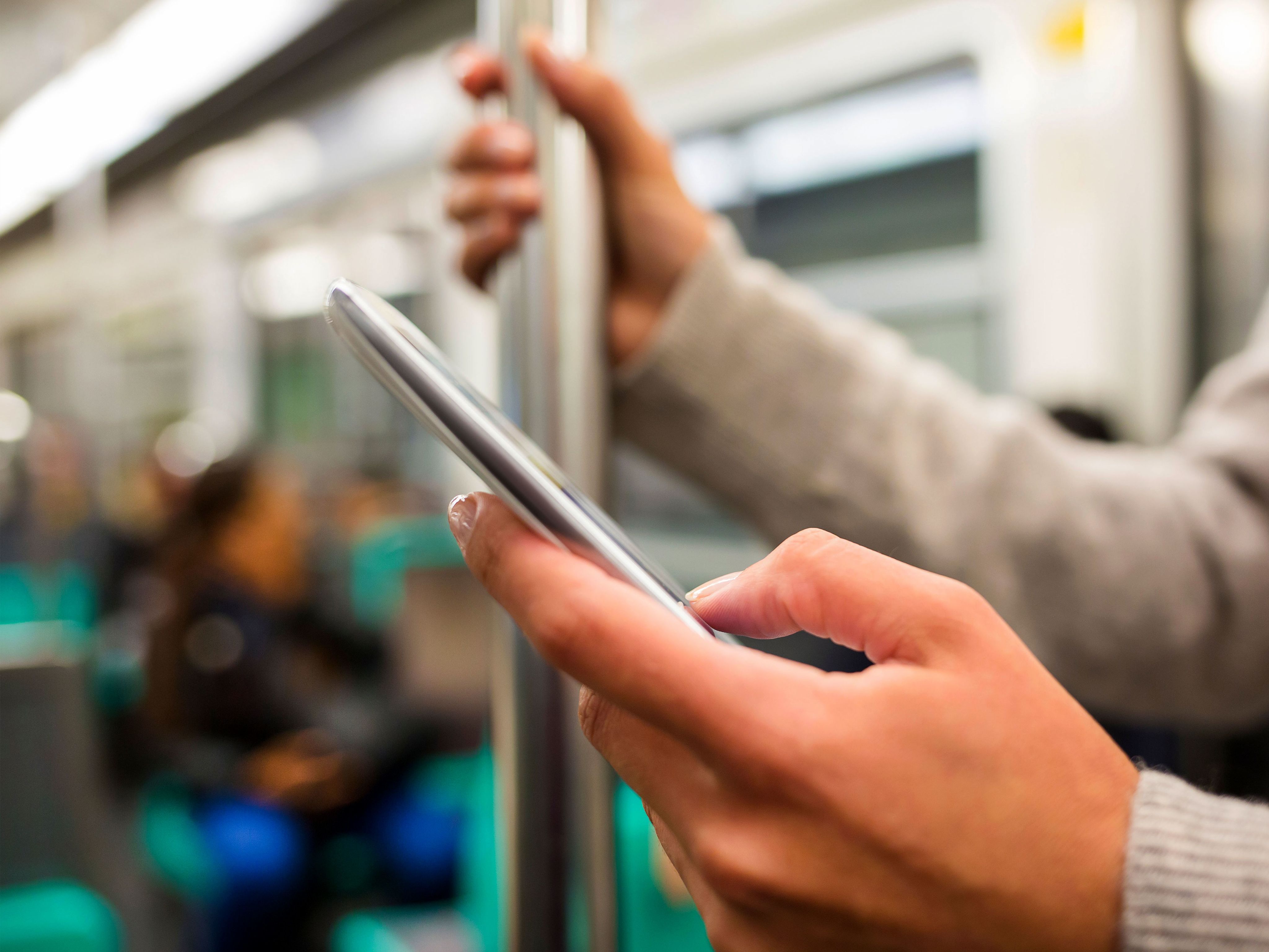 Person using smartphone on train