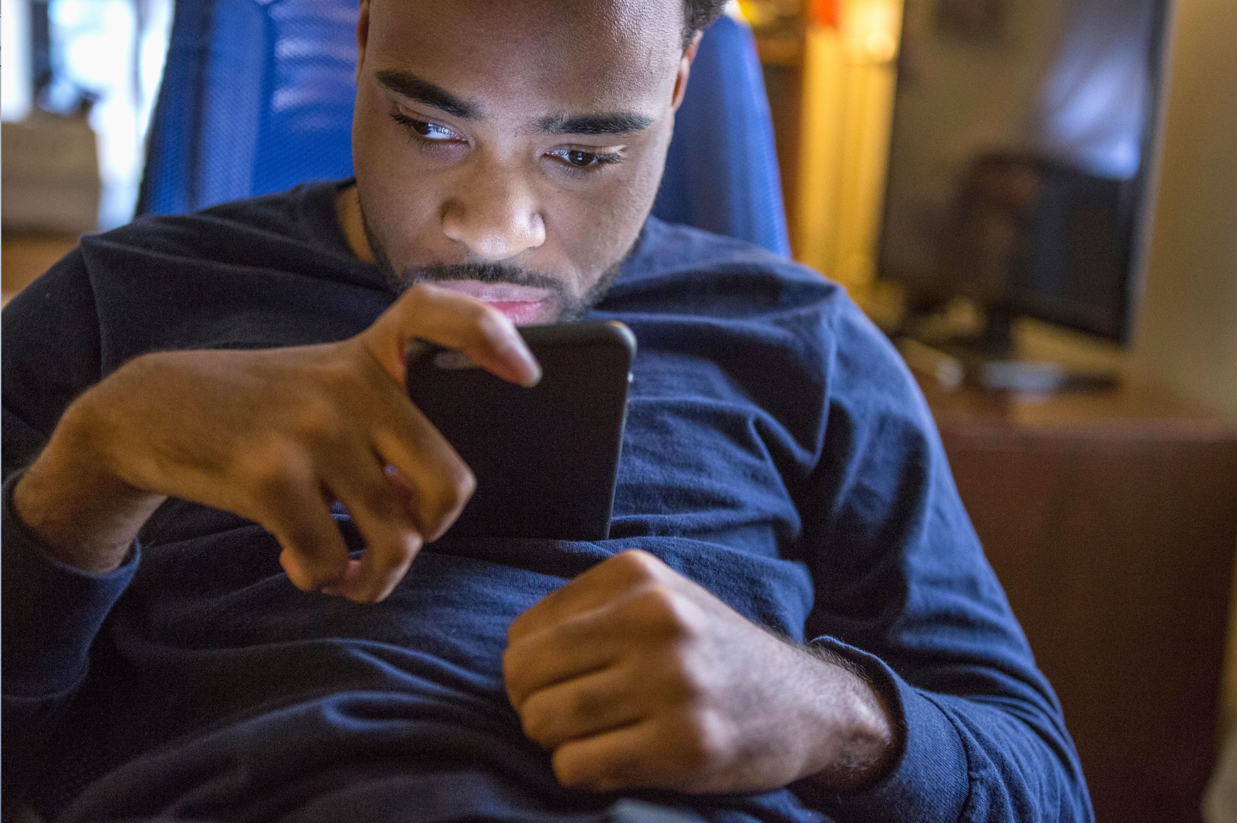 Man with cerebral palsy using smartphone