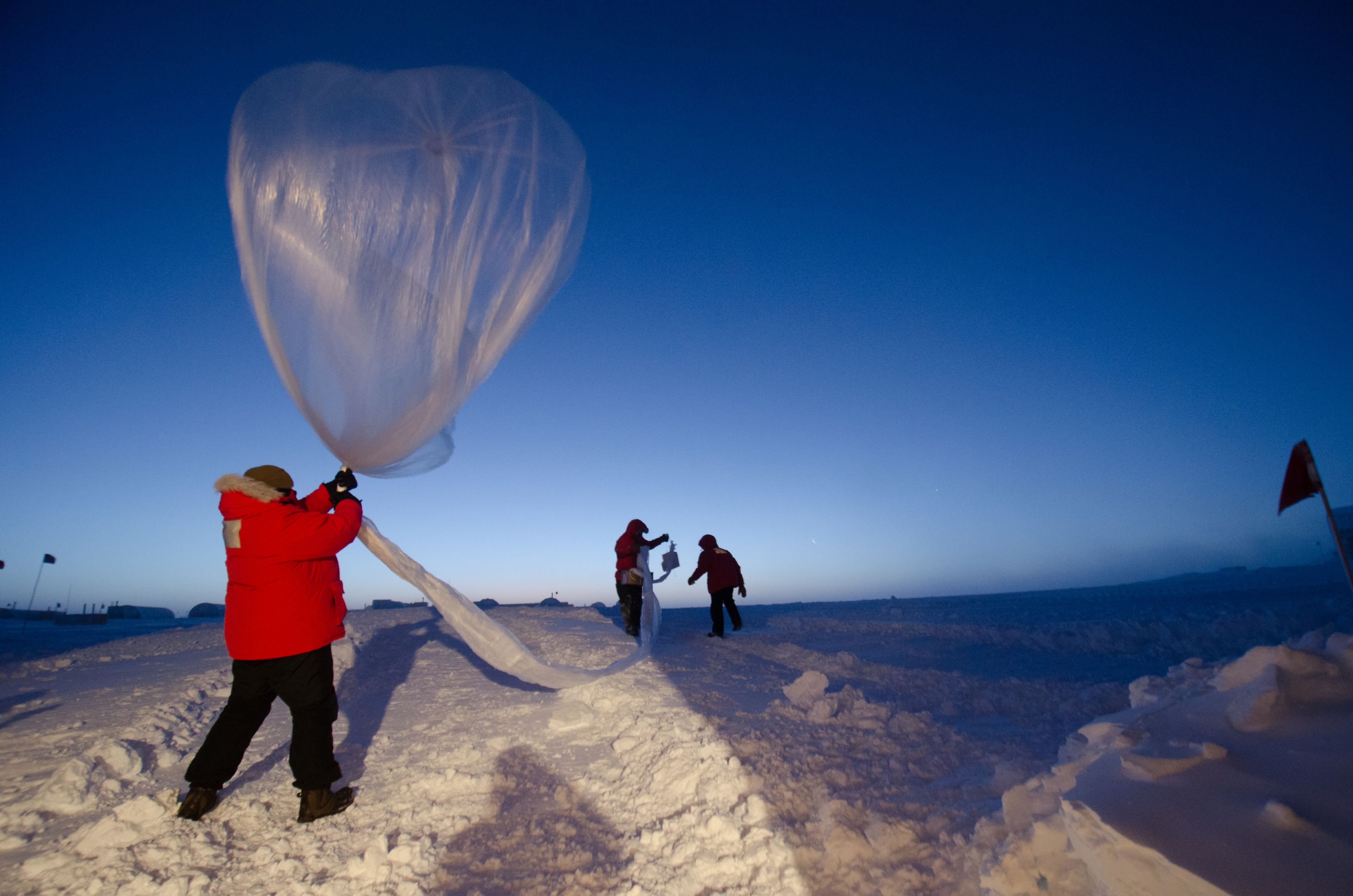Photo of a scientists working with climate change measurement tools in a remote cold climate