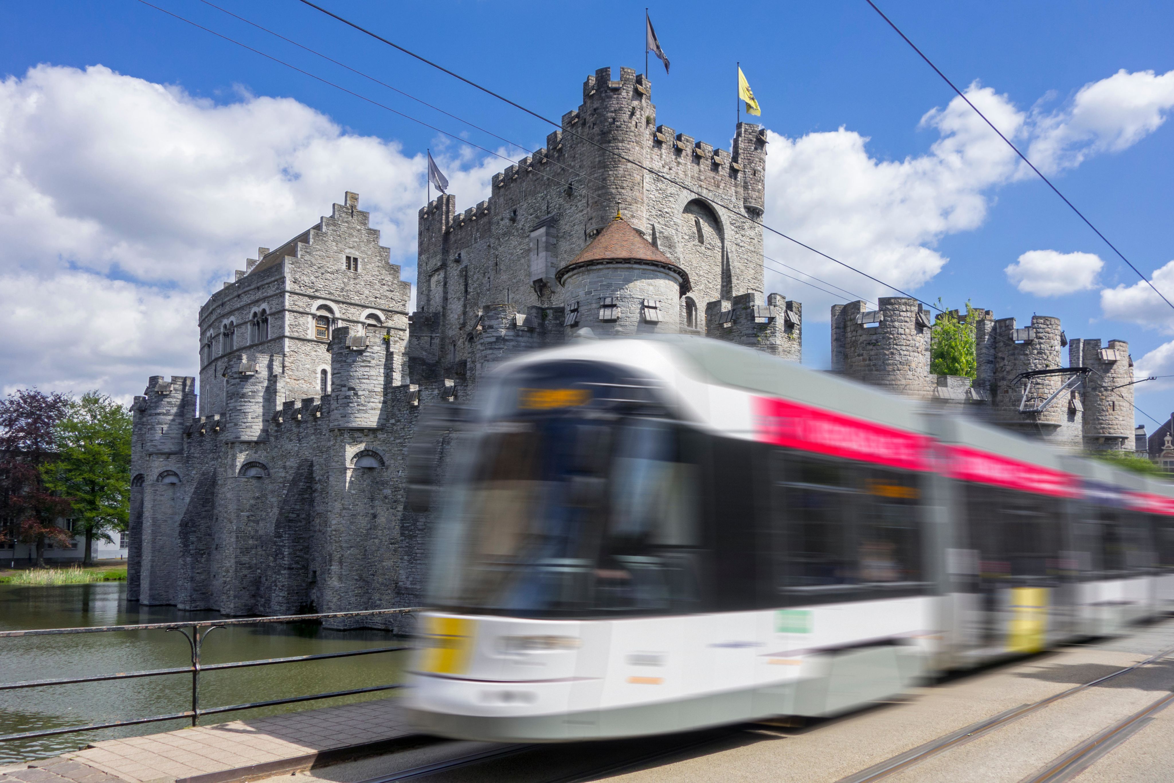 Blurred image of a tram in front of a castle in Ghent, Belgium