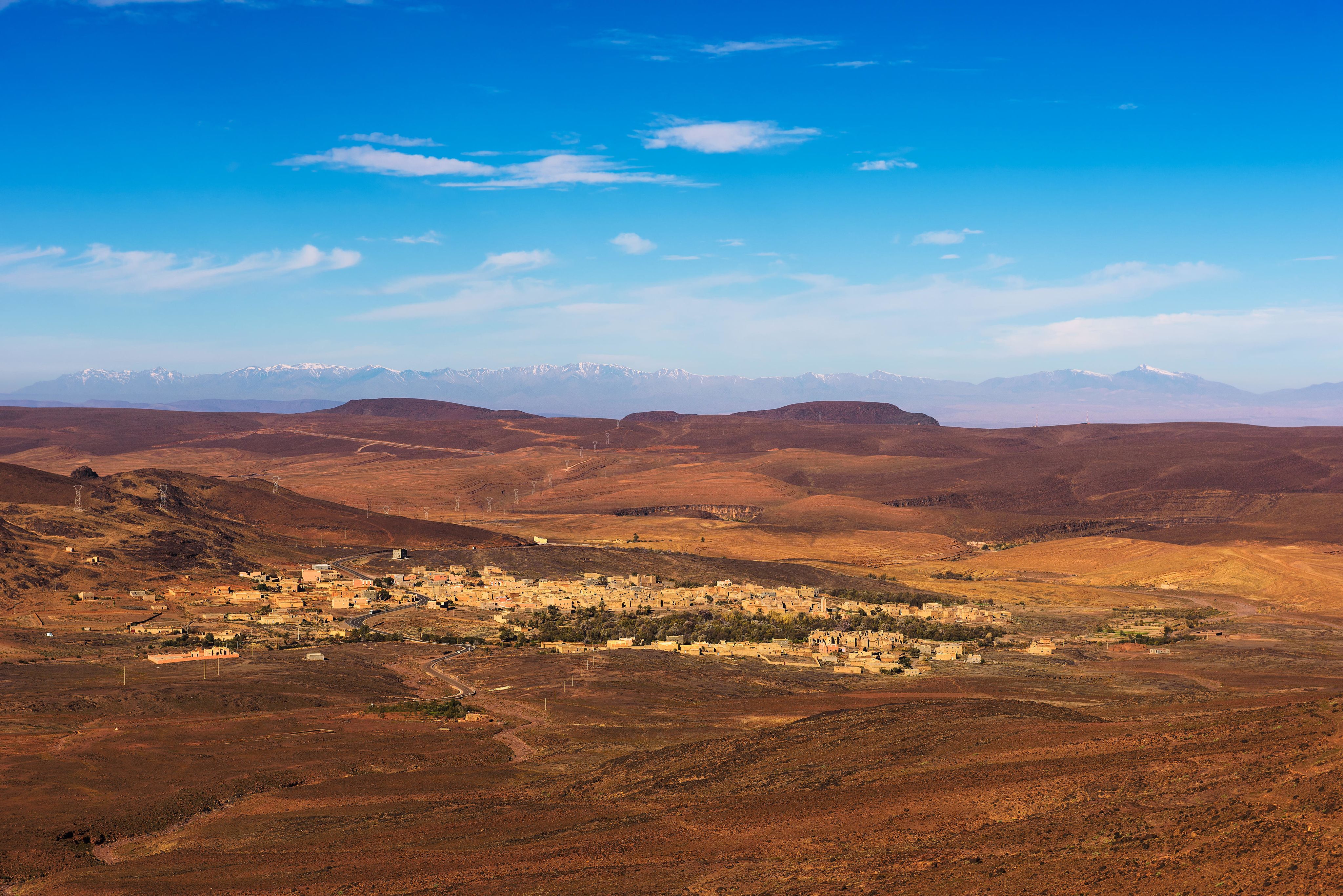 View over a village in Morocco with snowy Atlas mountains in the background