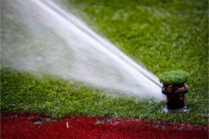Close up of a sprinkler on a sports pitch