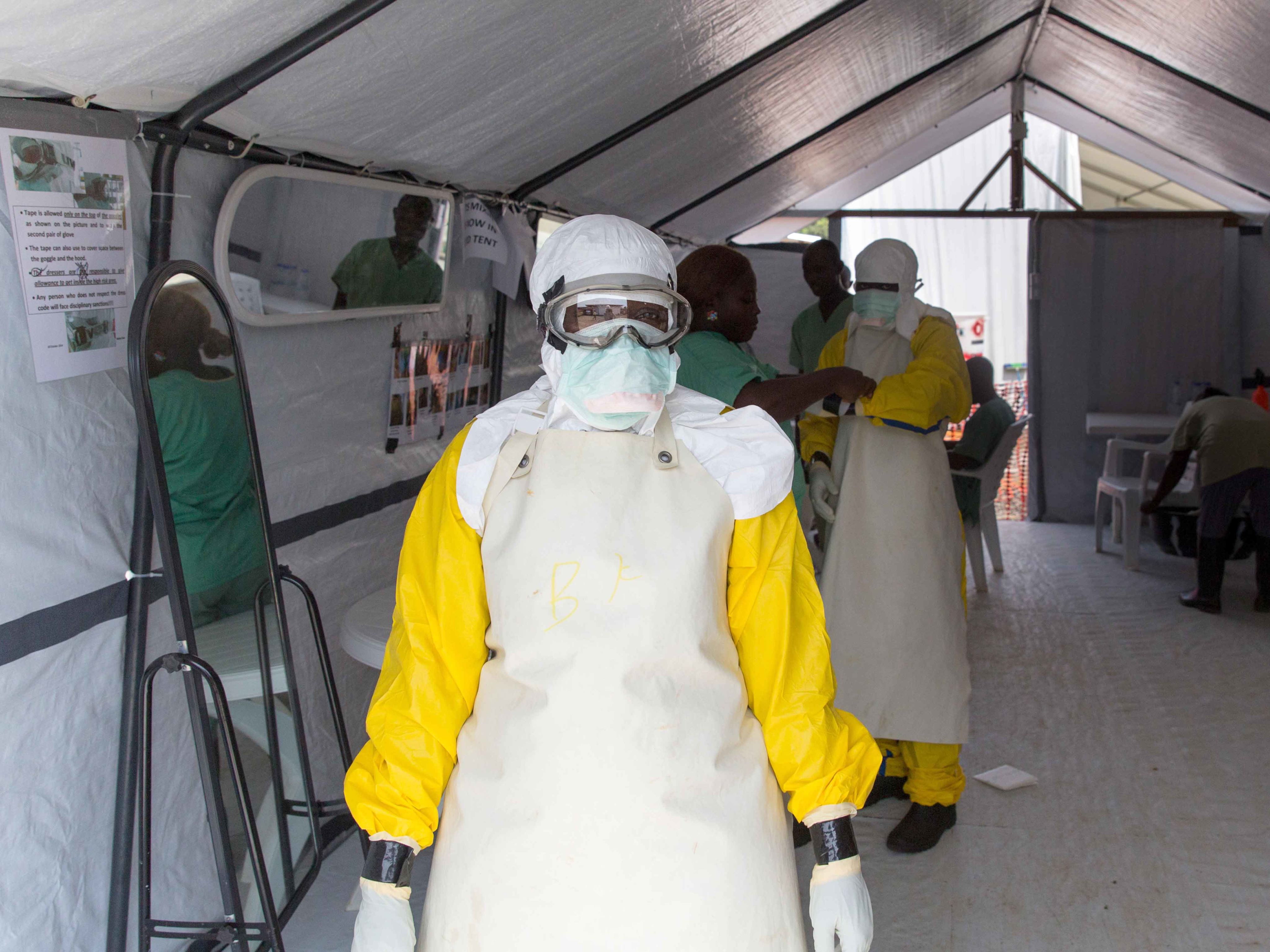 A health worker at MSF's ELWA 1 ETU prepares their PPE to go on shift in the contaminated zone to treat their Ebola patients