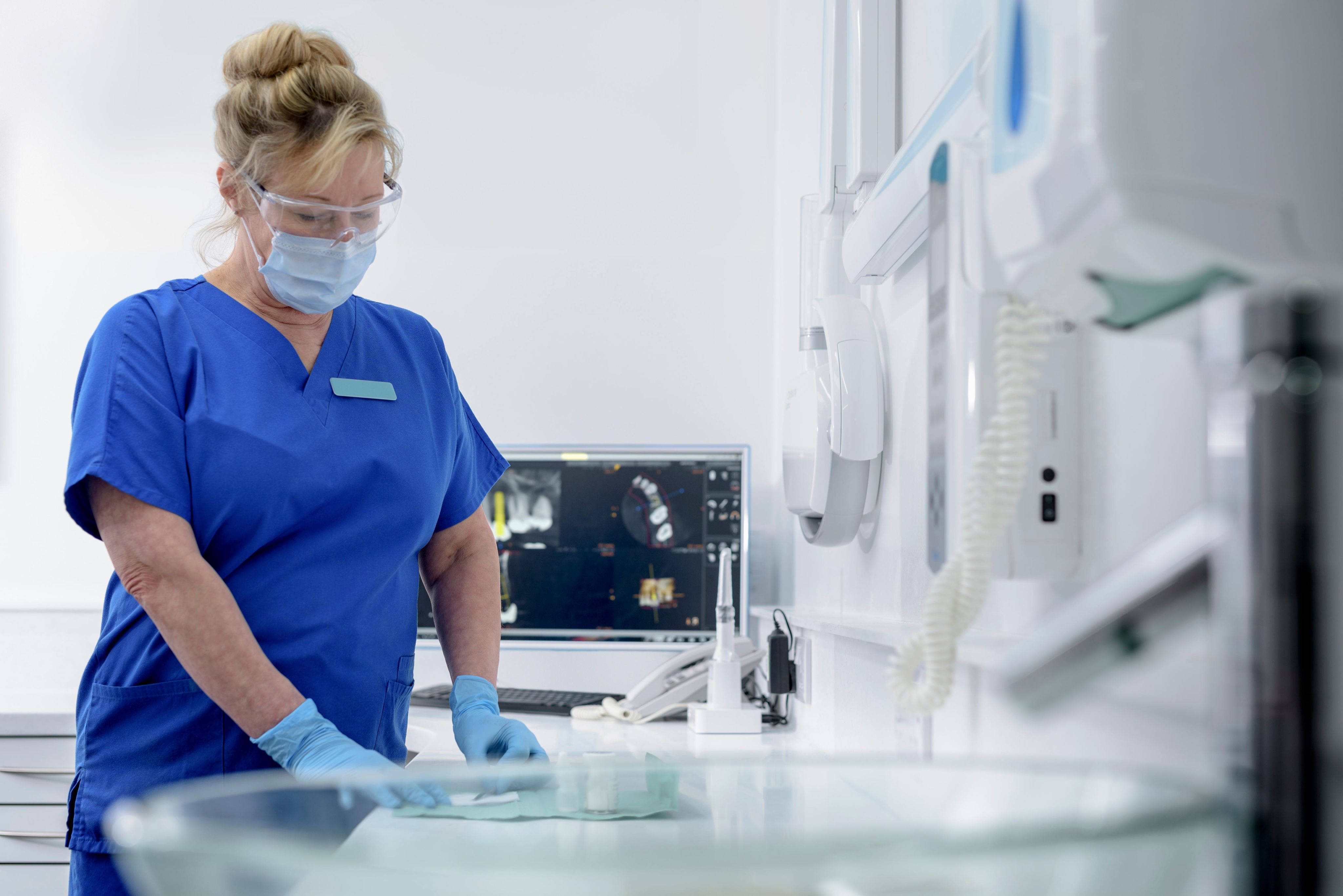 Dental nurse examining x-ray