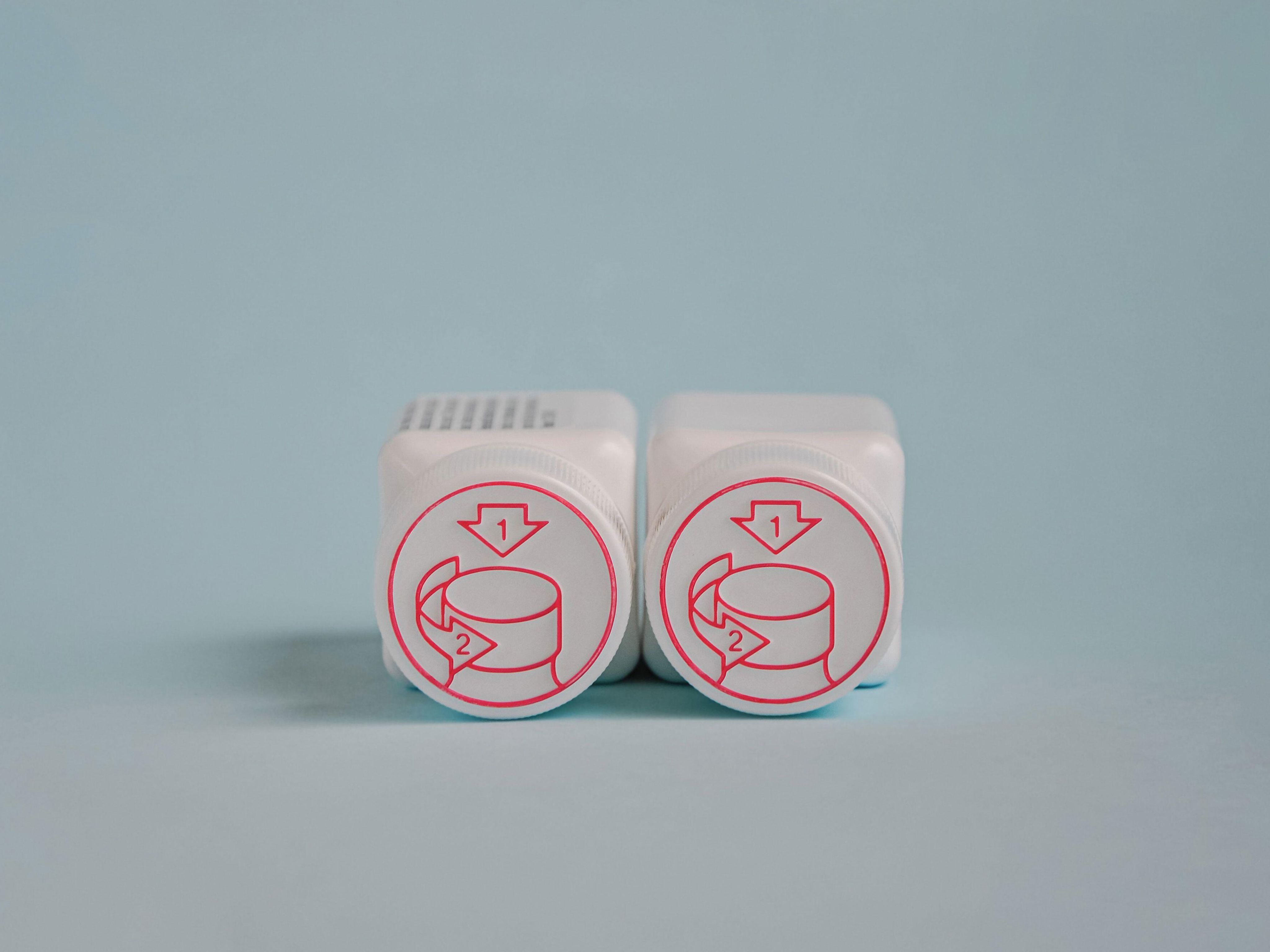 Child-proof lids of medicine bottles with blue background