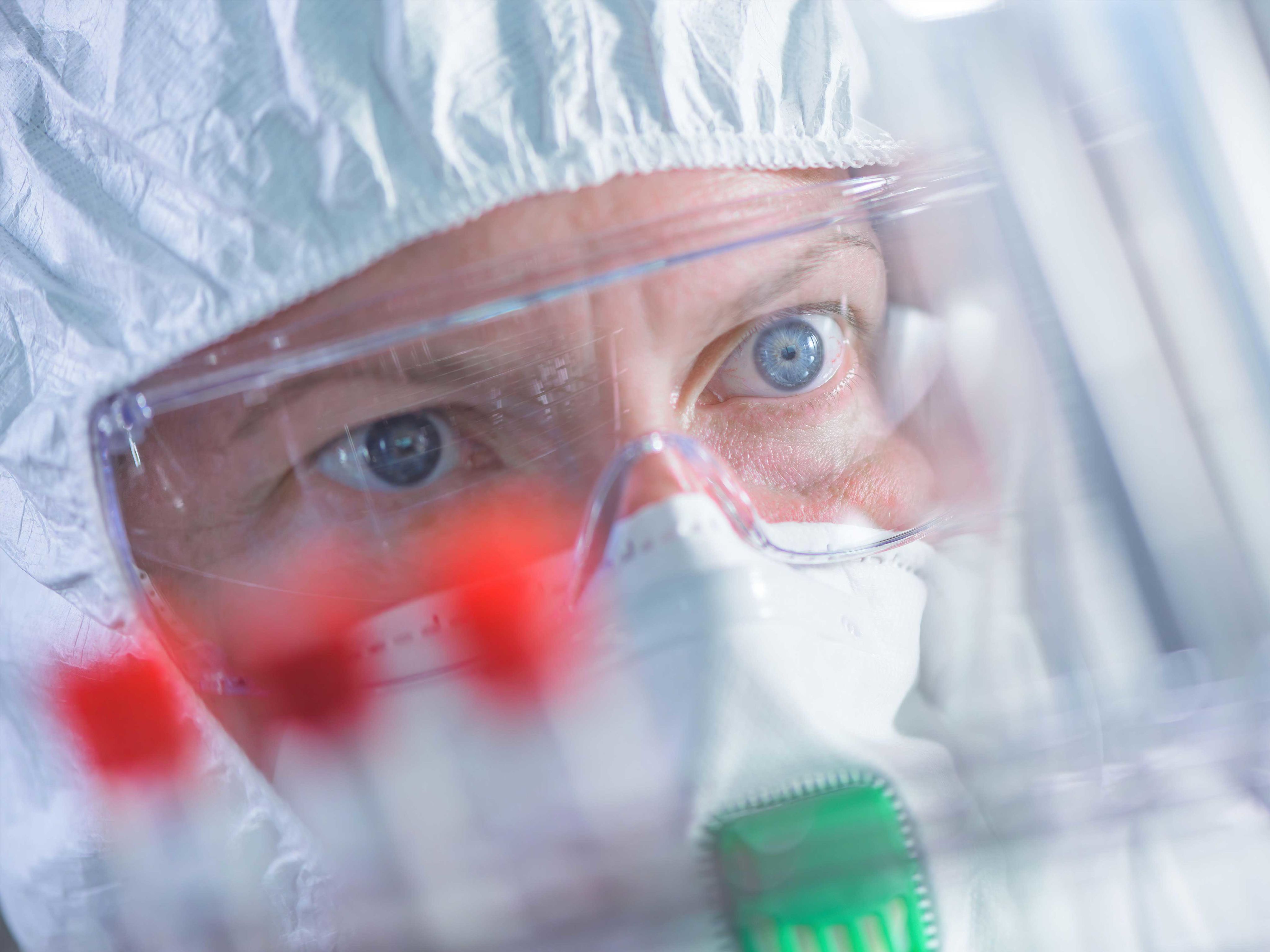Close up of virus researcher wearing facemask and goggles