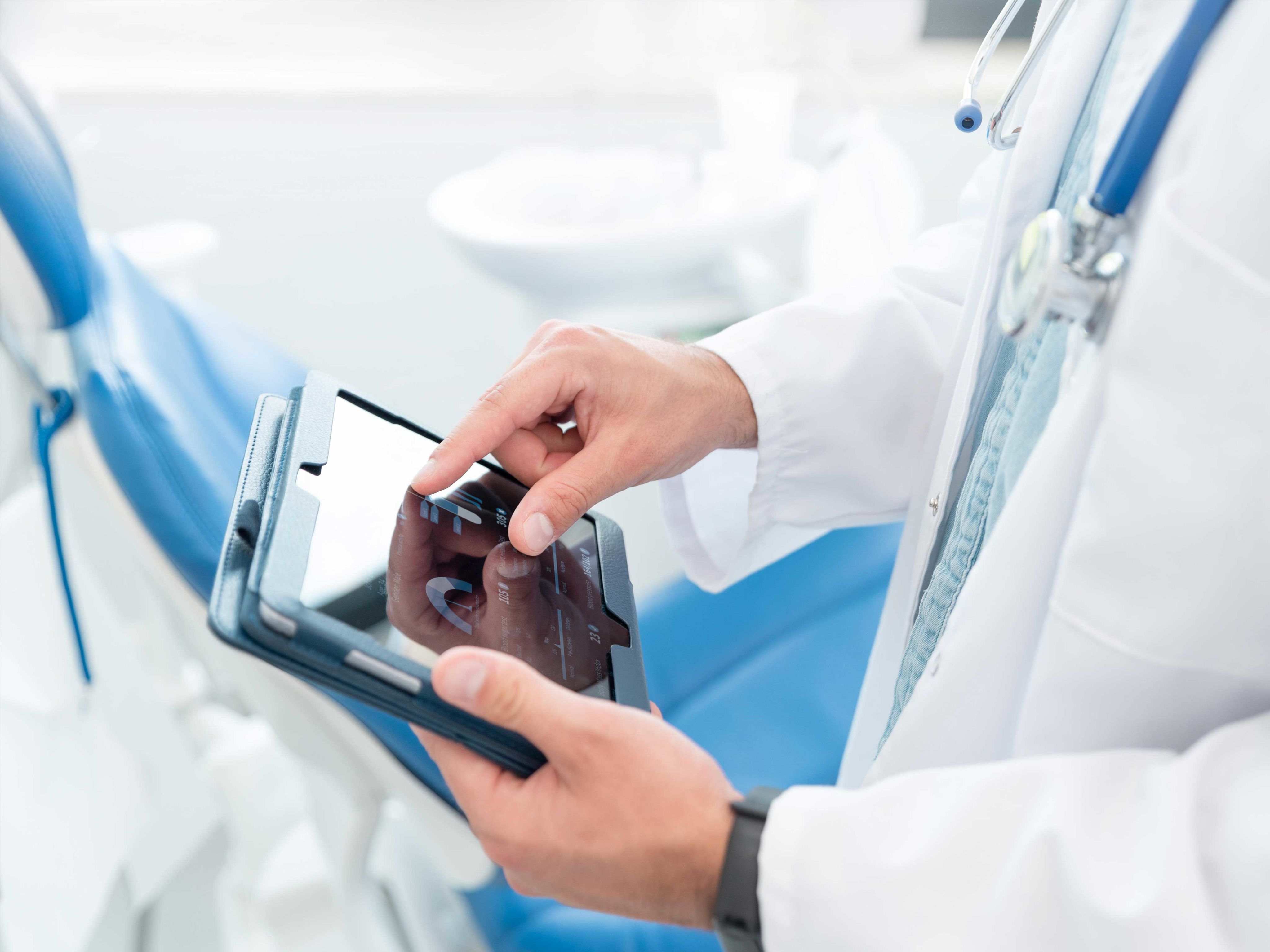 A close up of a doctor using a tablet computer