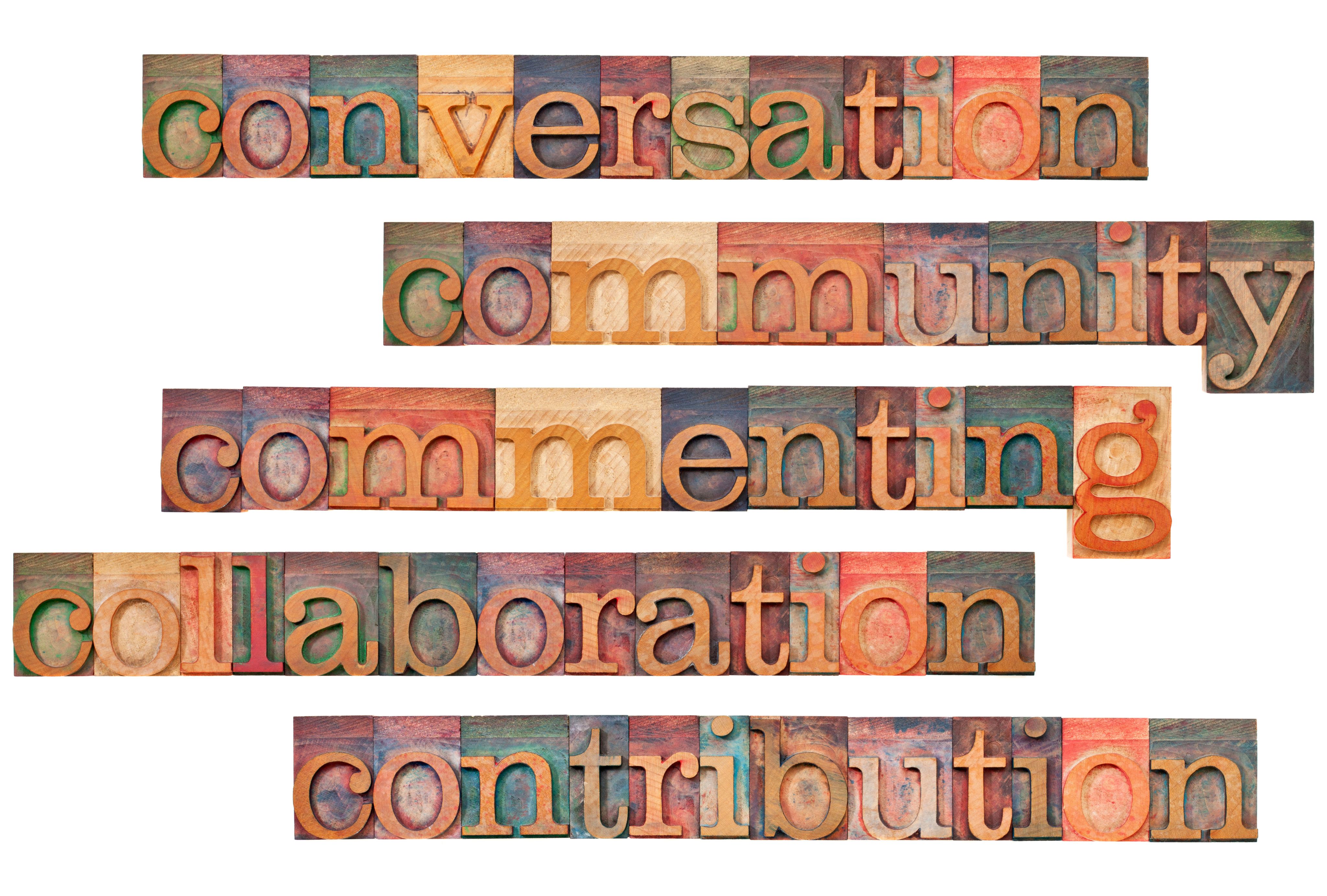 Conversation, community, commenting, collaboration, contribution, all spelled out in wooden block letters