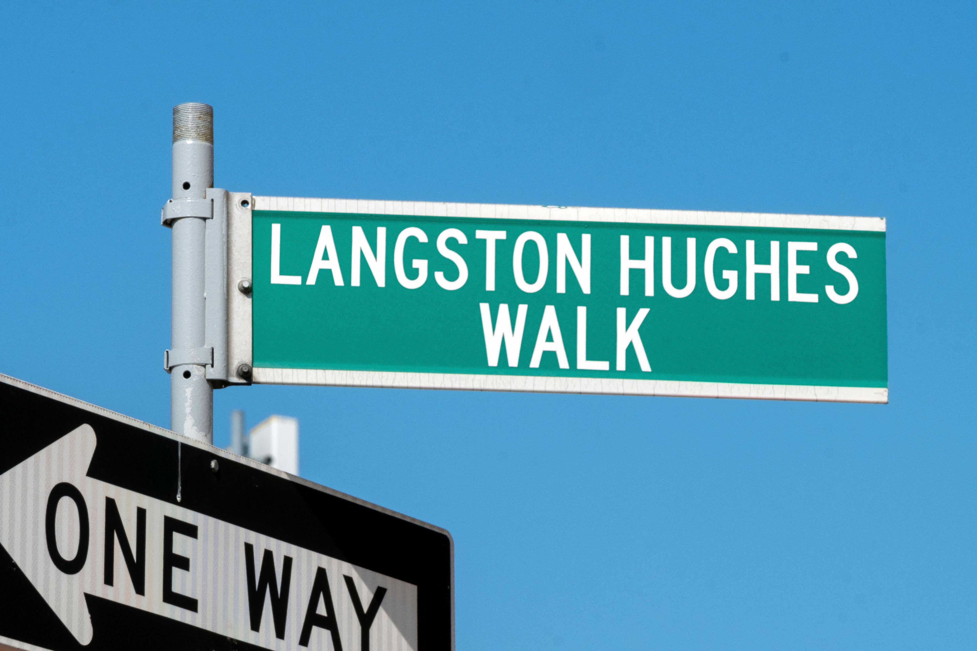 Photo of street sign for Langston Hughes Walk, named for influential Harlem Renaissance poet, Langston Hughes.