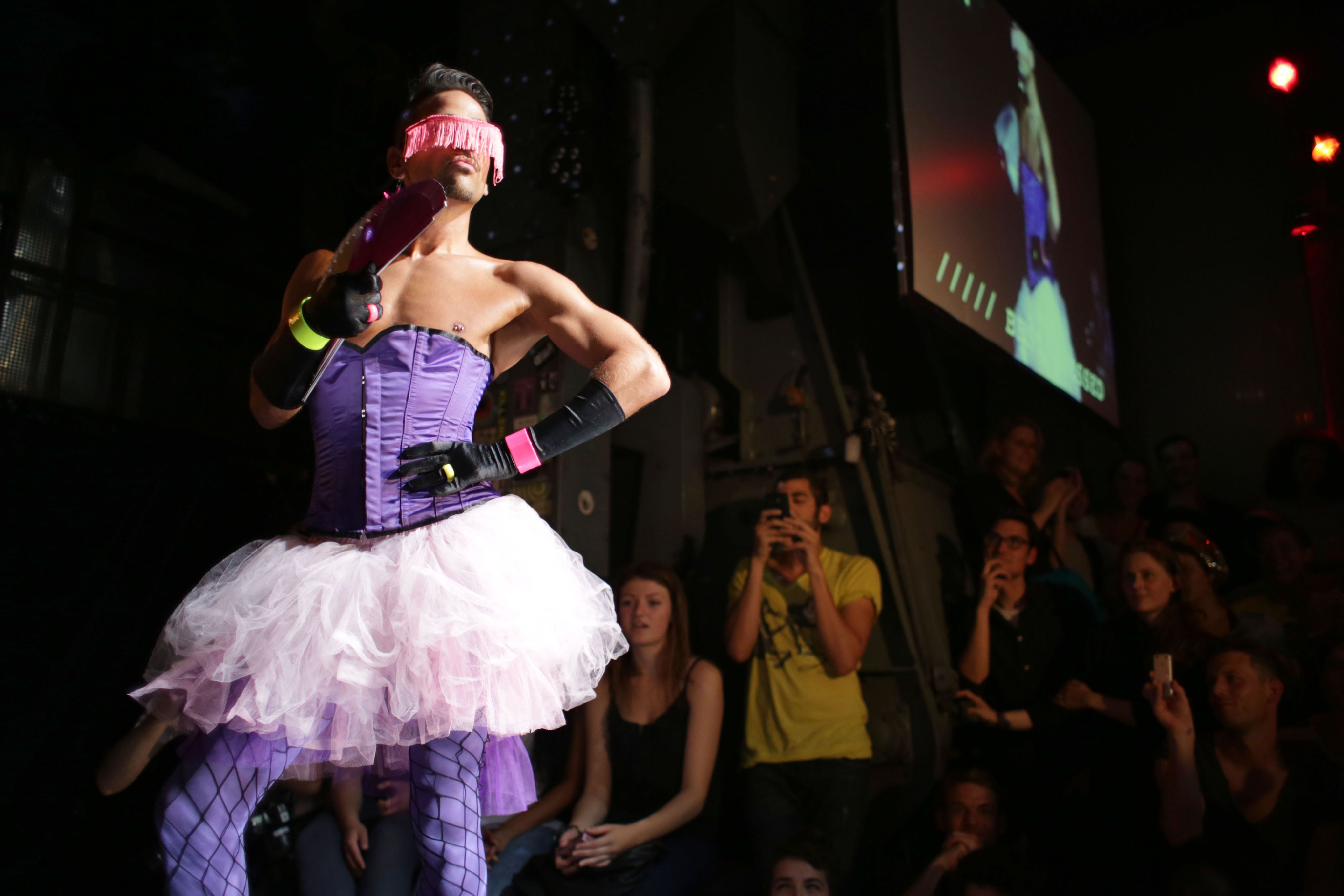 A dancer performs on stage at a Voguing dance festival.