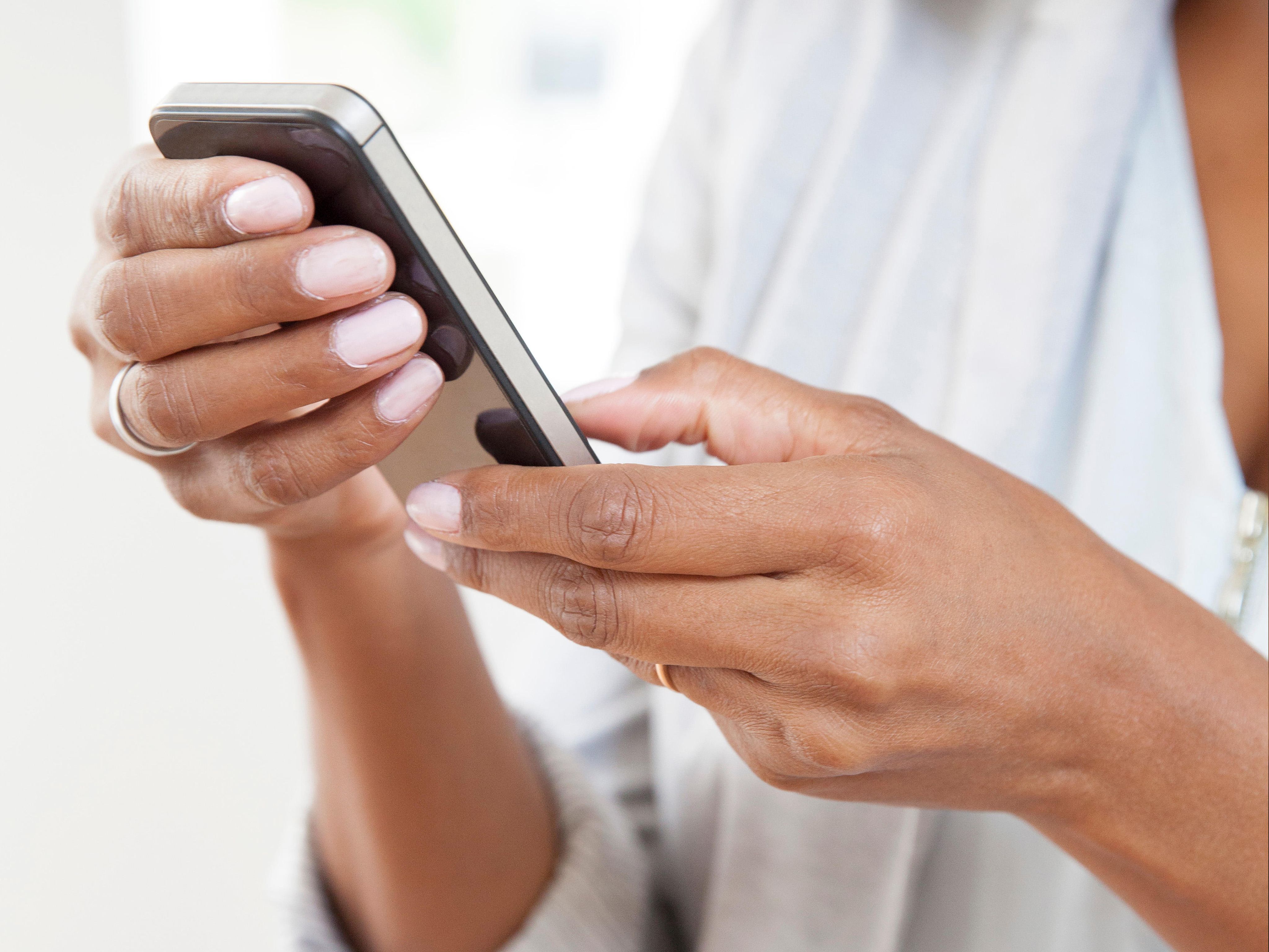 Close up shot of a person's hands using a smartphone