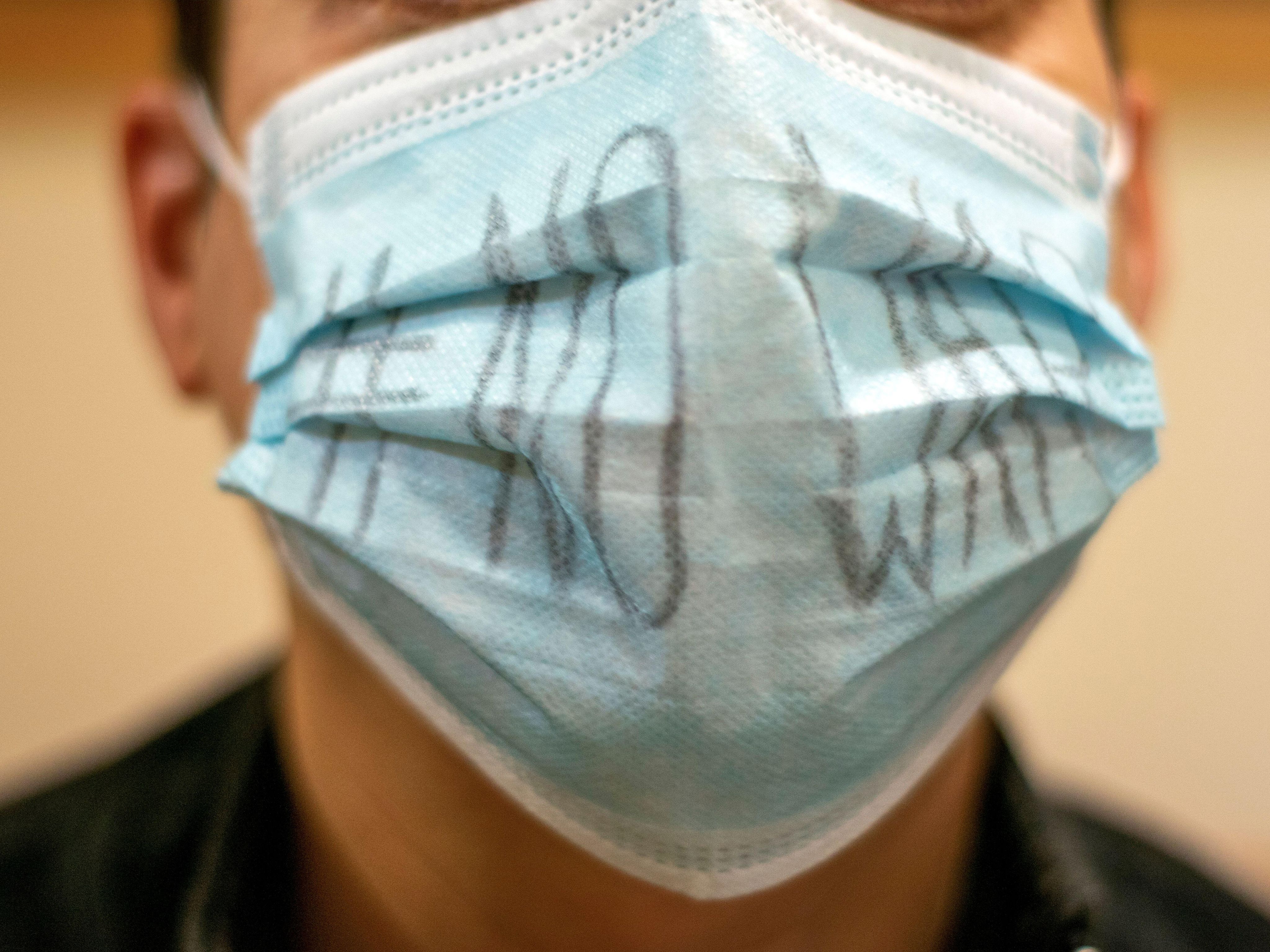Man wearing surgical mask with 'no war' slogan