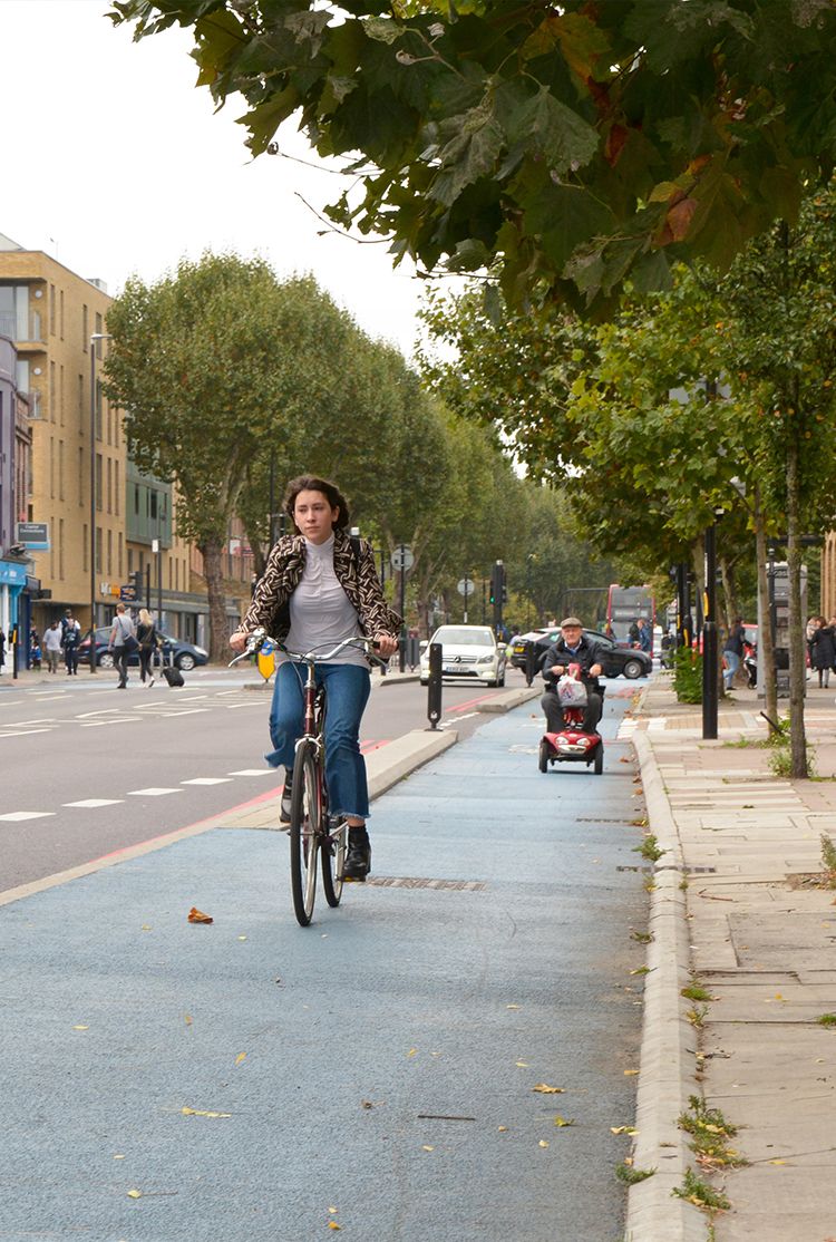Cyclist and mobility scooter user on a cycle lane in London