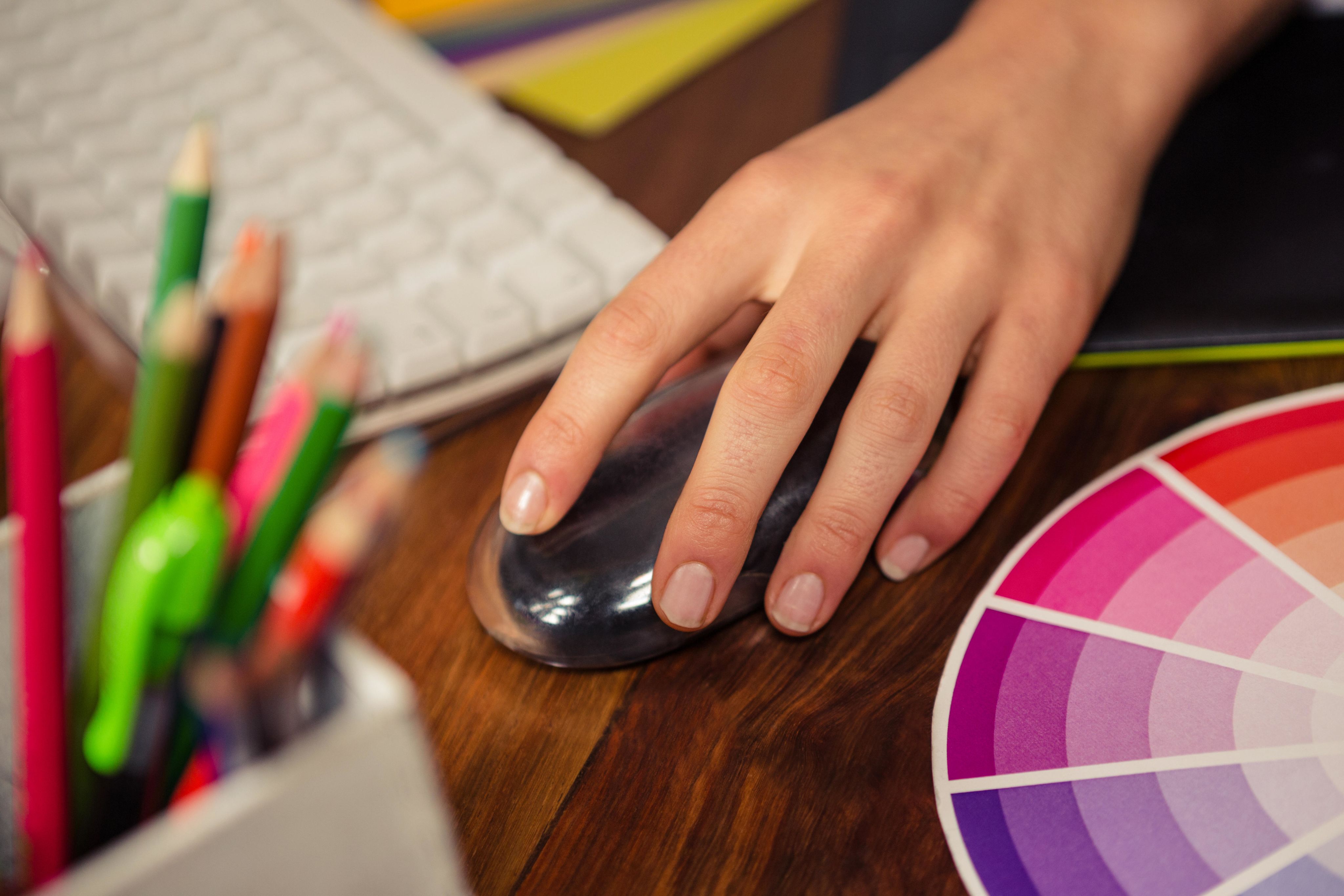 Close up of hand using a mouse to manipulate an image