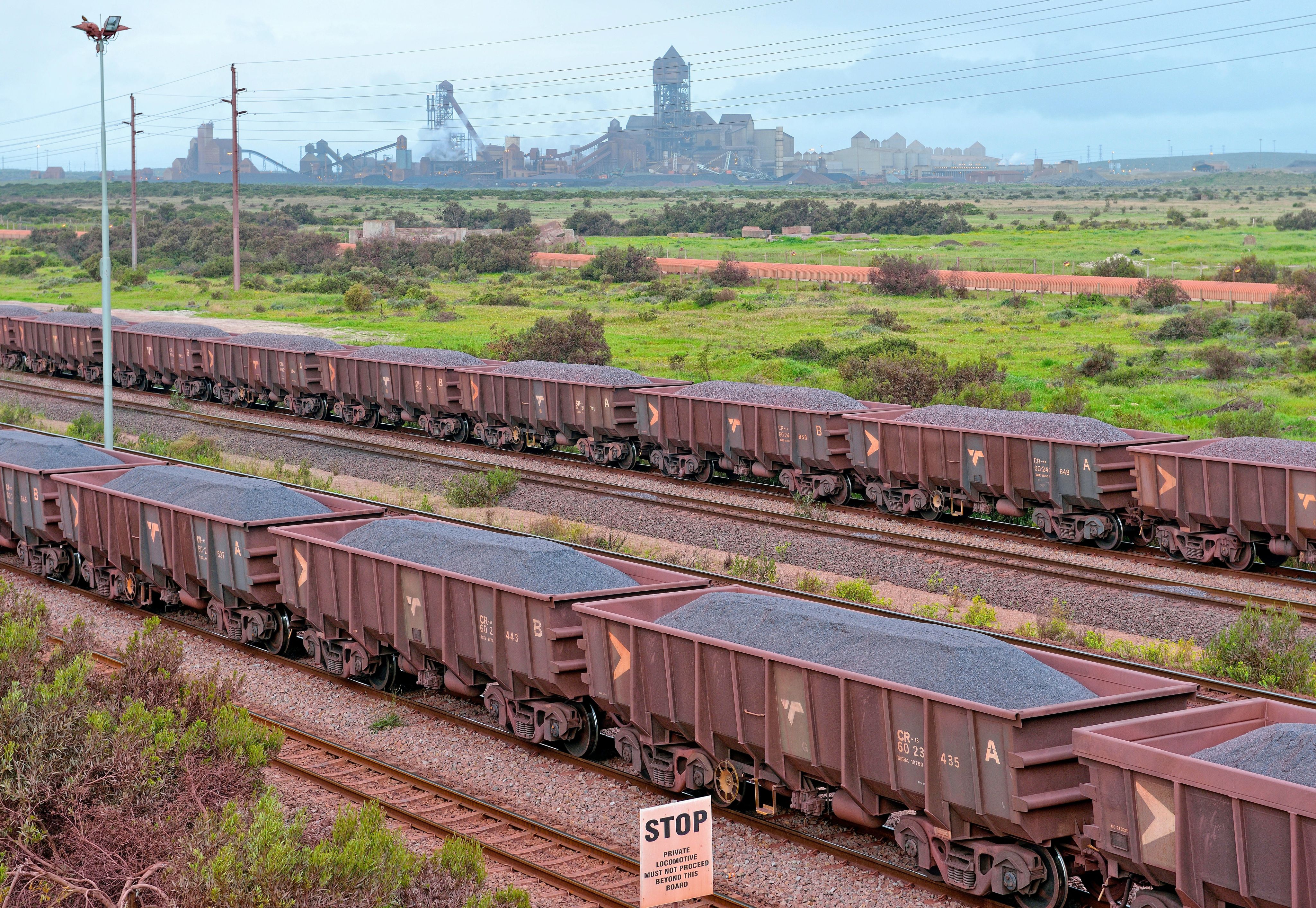 Iron ore trucks in front of a steelworks