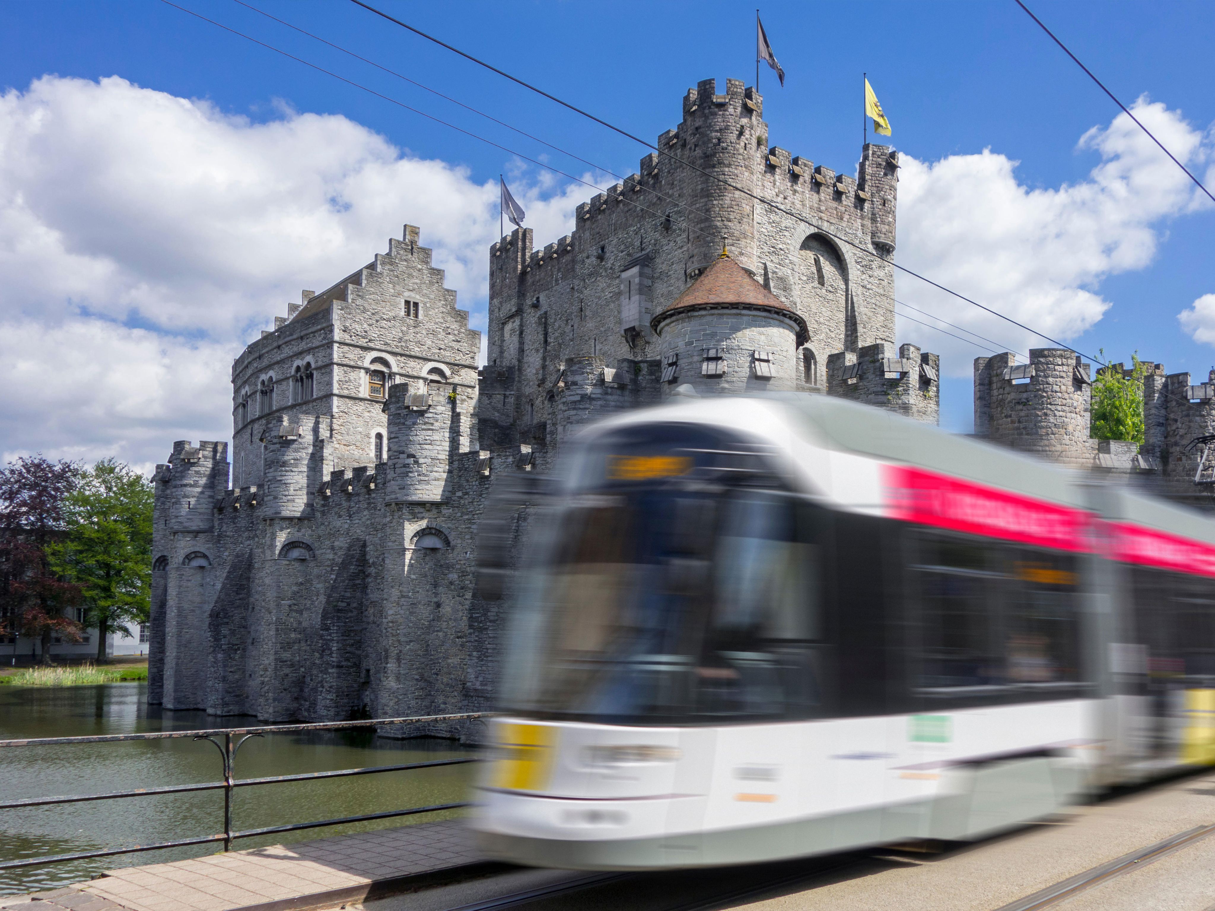 Tram passing a castle in a European city