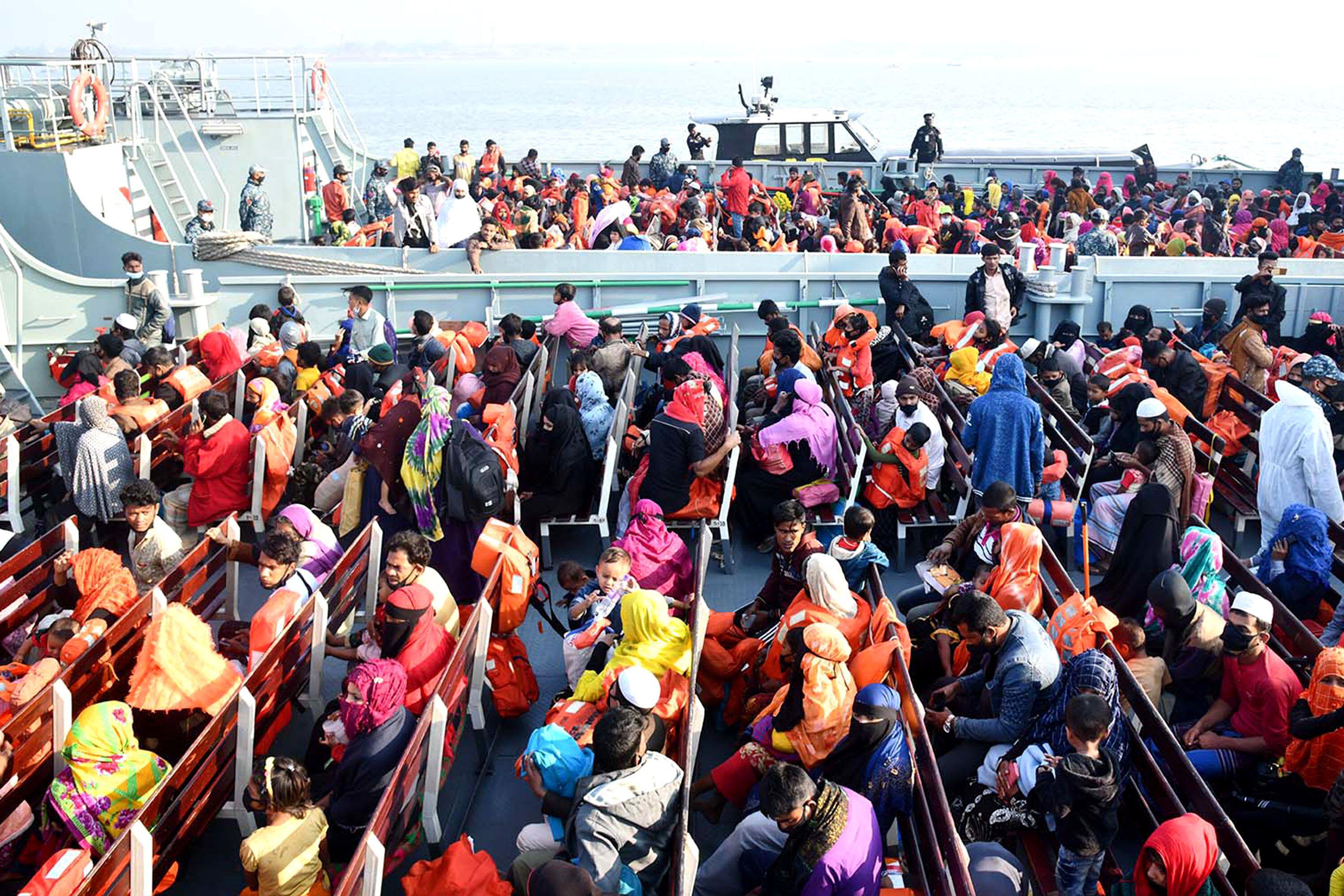 Rohingya refugees sit on a Bangladesh Navy ship