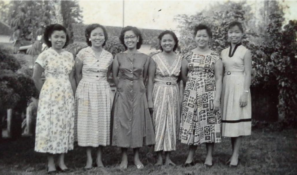 Black and white photo of Alanna Kamp's maternal grandmother and her sisters in Makassar, Sulawesi, Indonesia (1950s). There are 6 women all wearing hear and dresses that were the the fashion at that time.