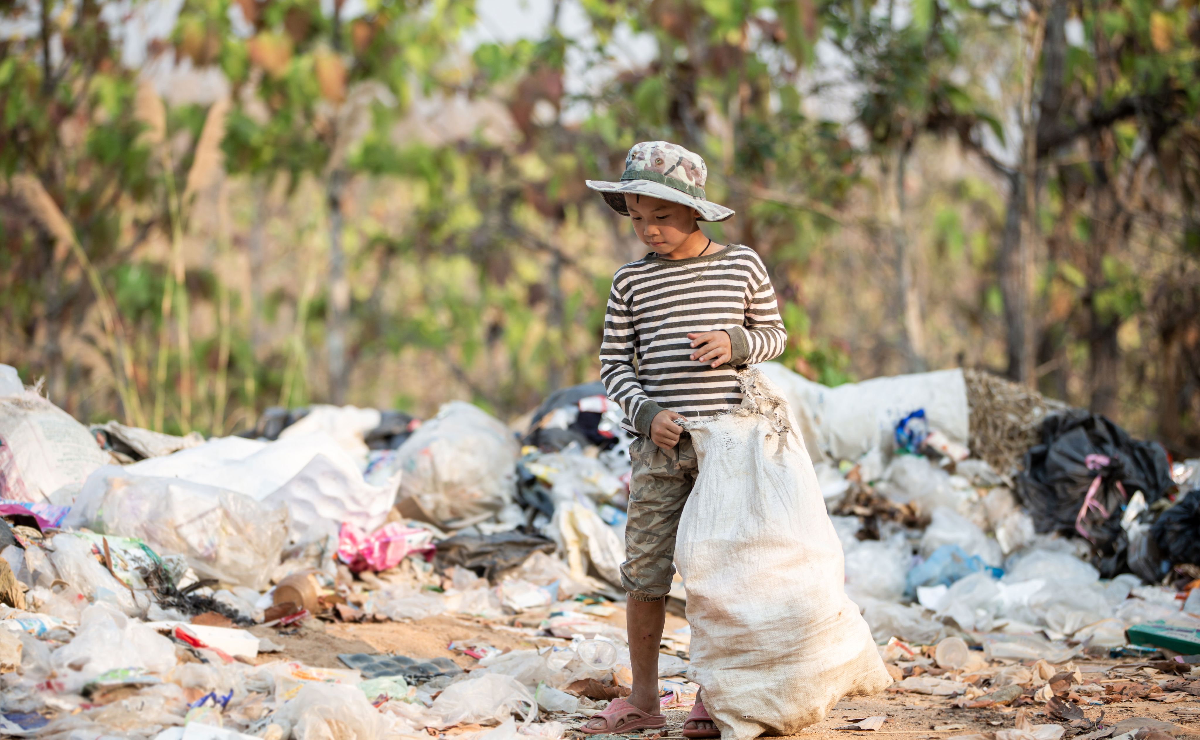 Child picking up rubbish on beach