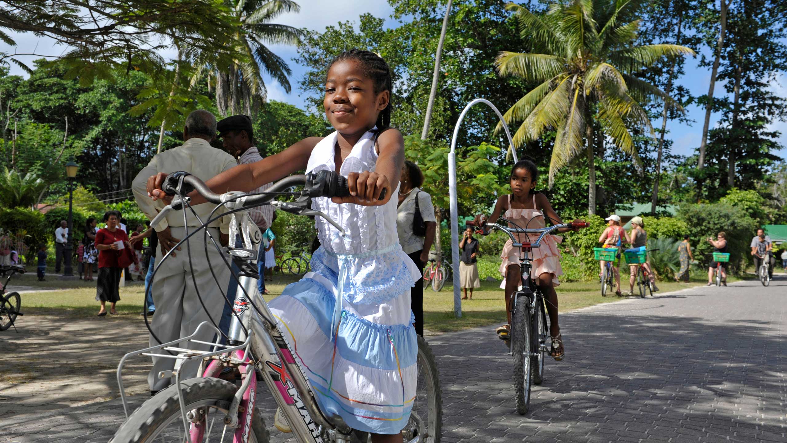 Young girl riding a bike in tropical country