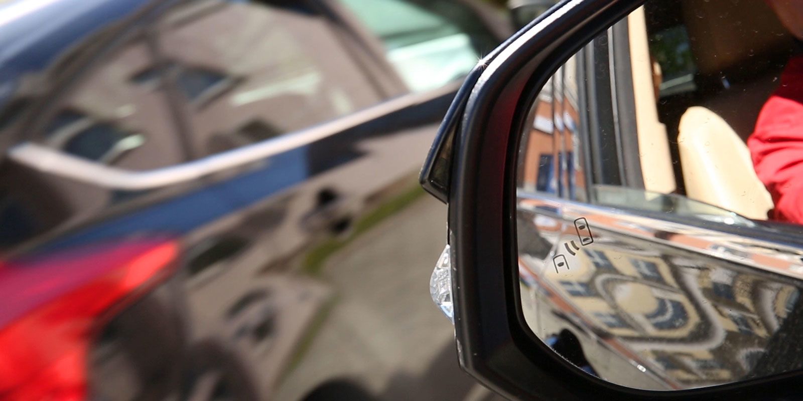 Blind Spot Monitoring system warning light icon in side view mirror of a modern vehicle