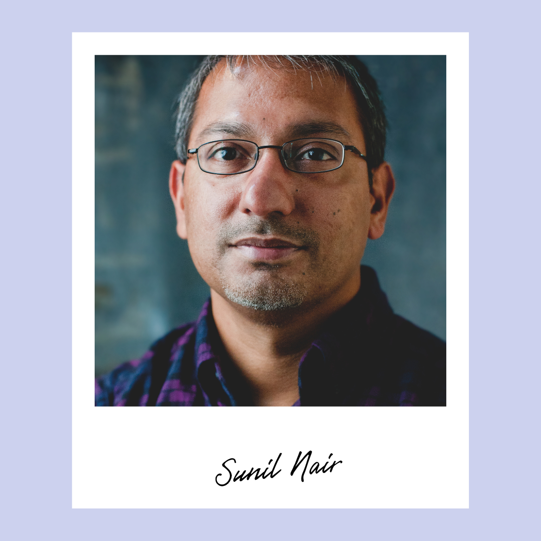 Image of Sunil Nair. He has short hair, wire rimmed glasses, and a purple and blue plaid dress shirt.