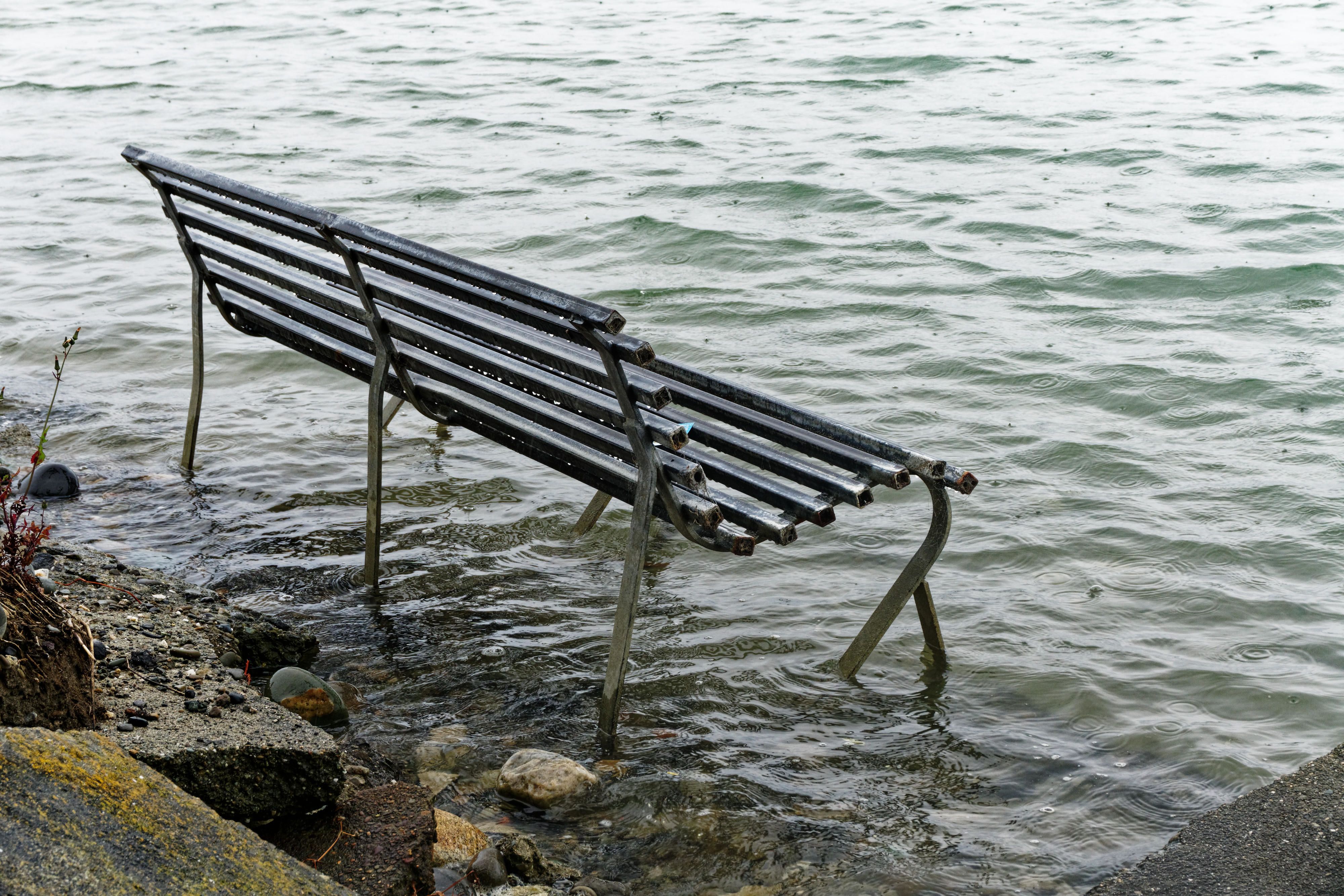 Park bench swamped by a rising sea level, New Zealand east coast