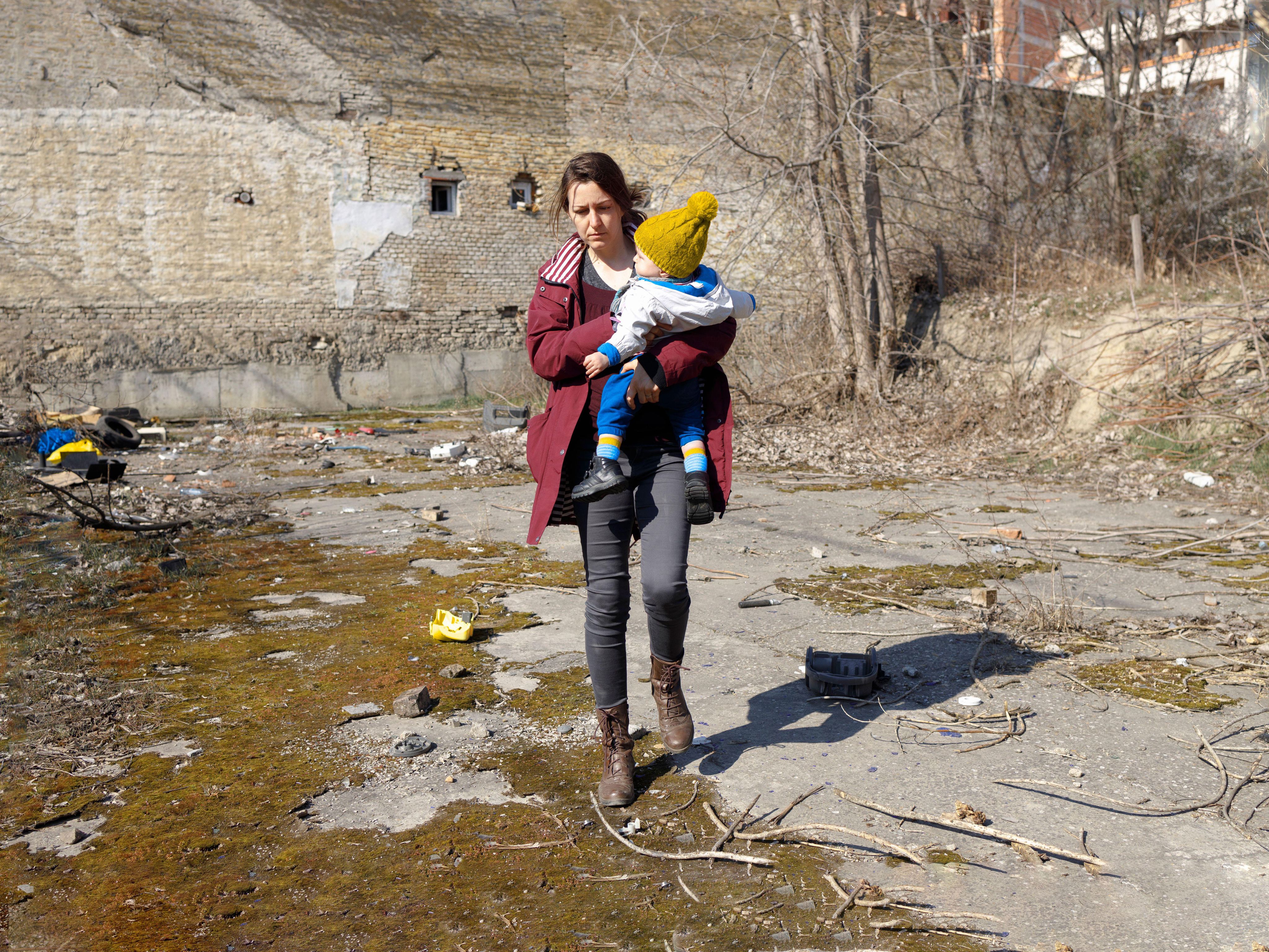 Woman refugee holding a young child