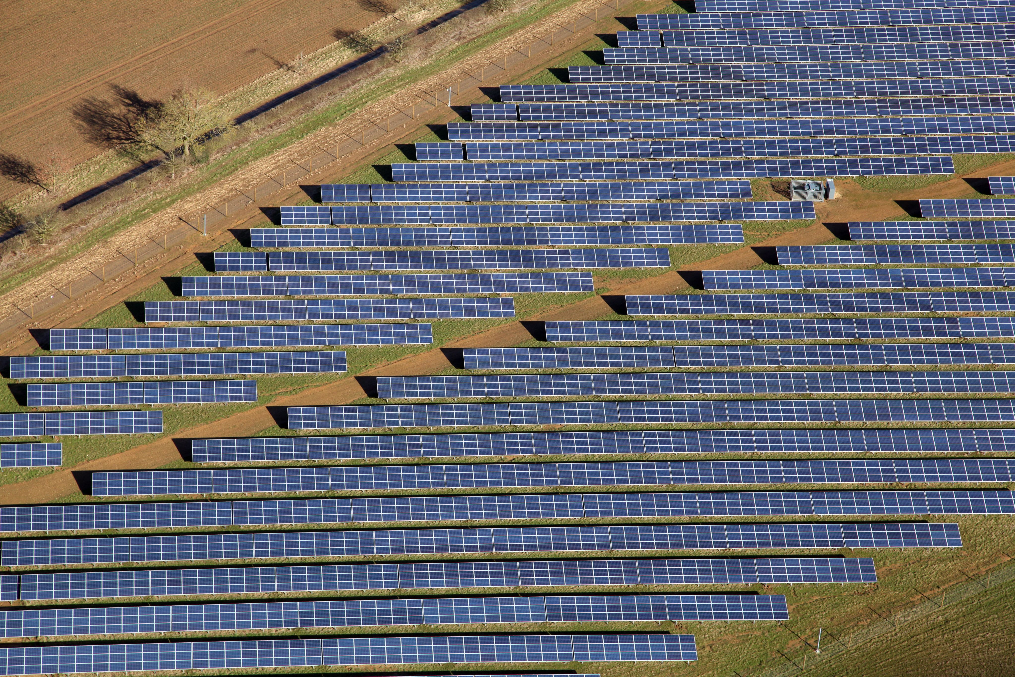 a close-up aerial view of solar panels (pv cells) on a solar farm in the UK