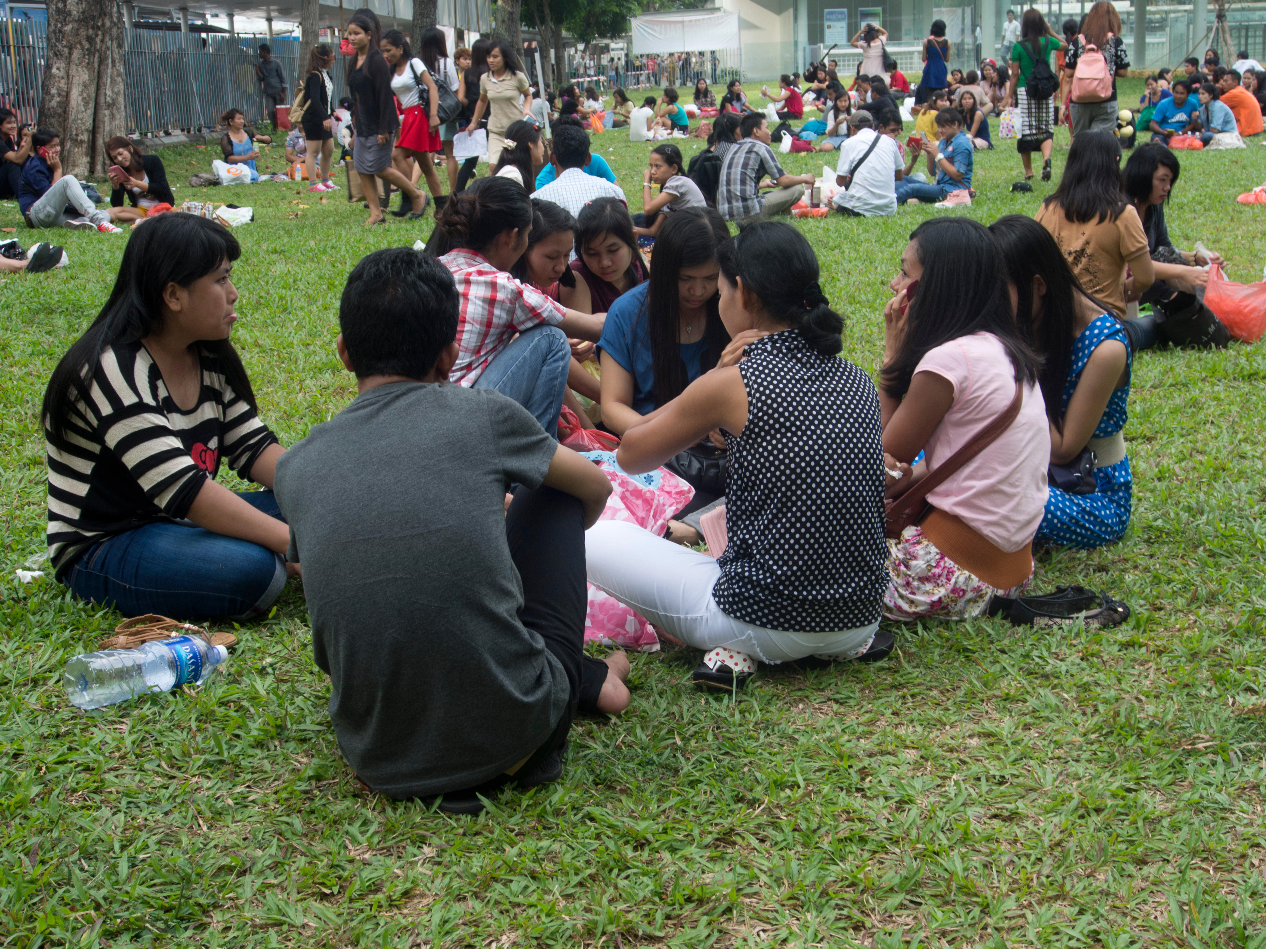 Migrant domestic workers from Myanmar enjoy a day off in Singapore.
