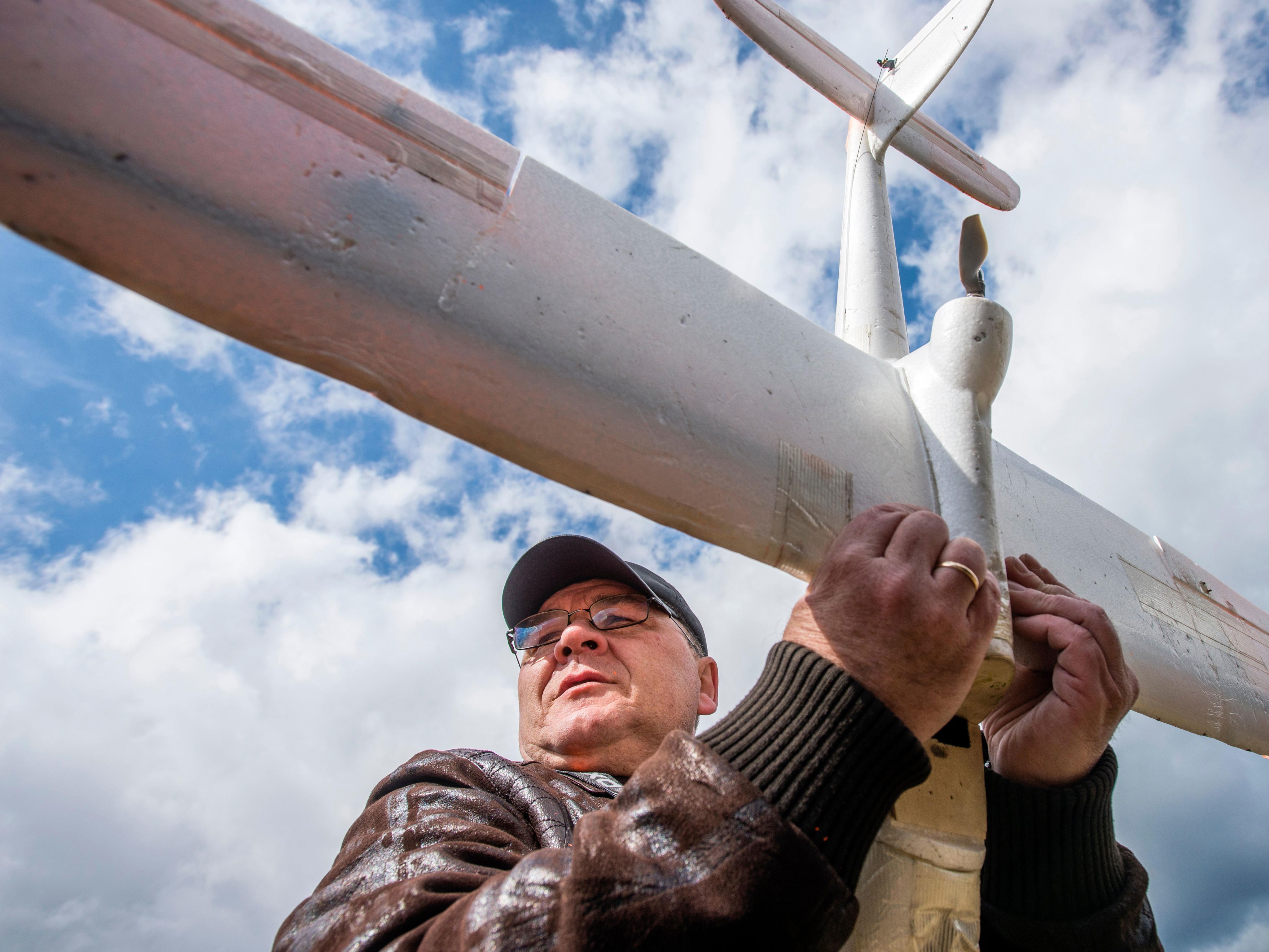 A military trainer holds a drone