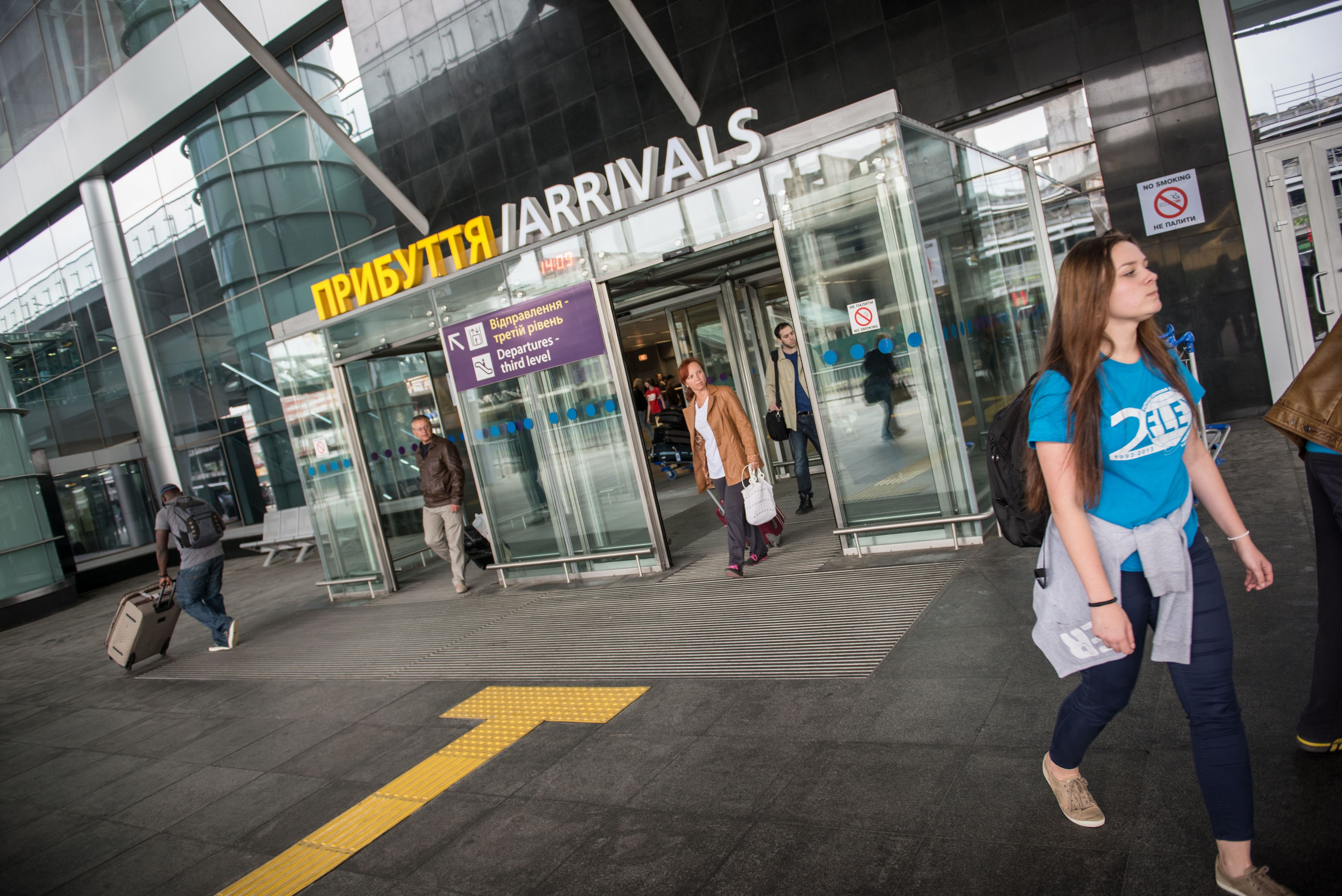 People walking through the arrivals gate at an airport