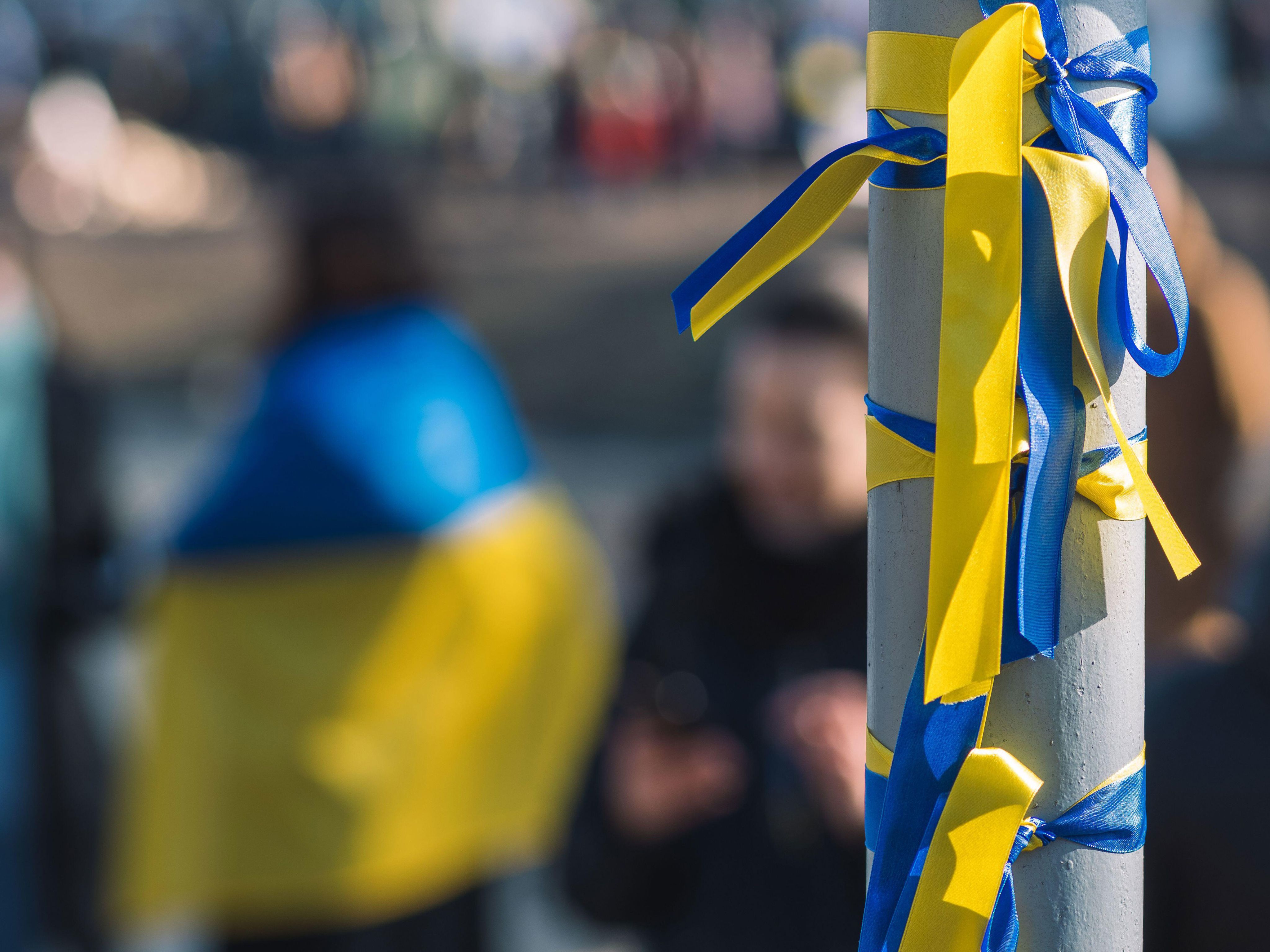Ribbon in colors of Ukraine flag tied to utility pole