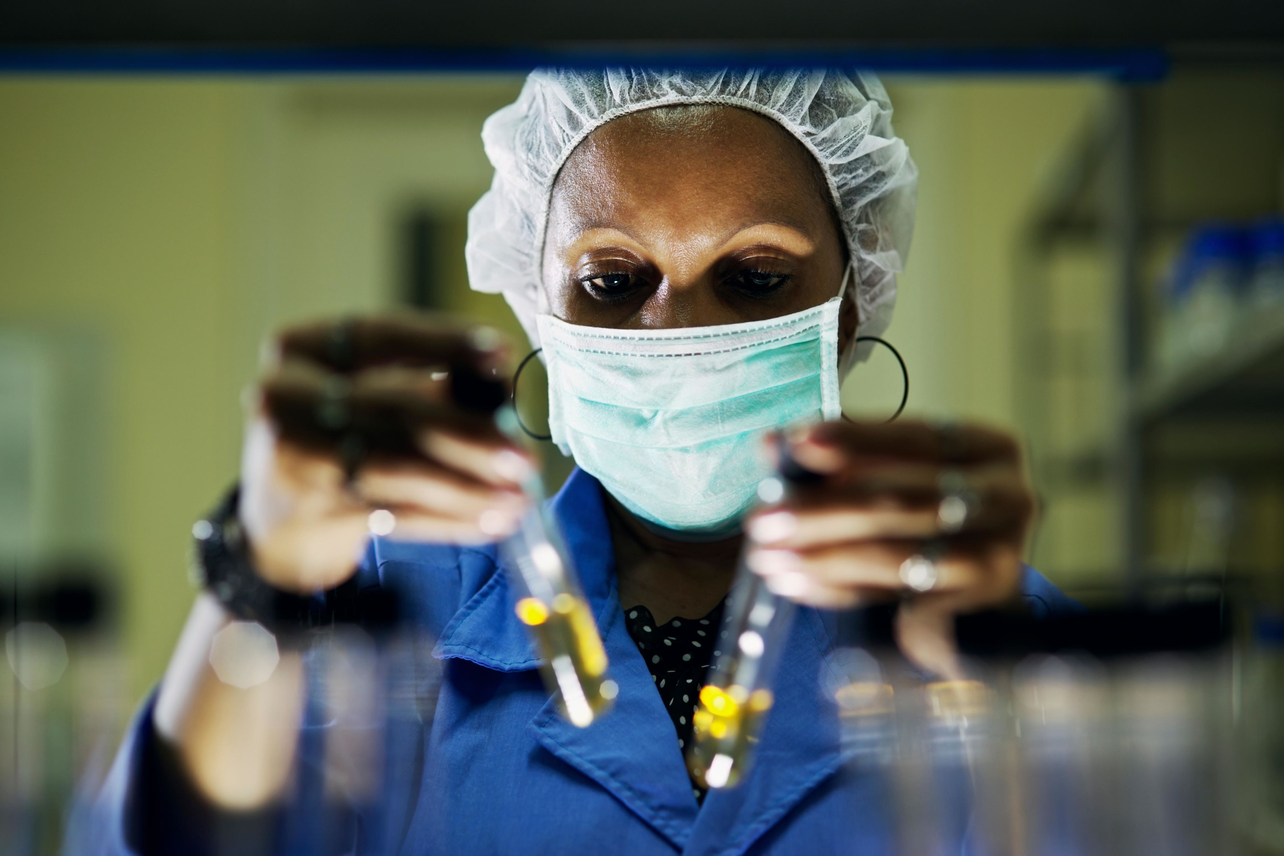 Close up of female scientist wearing a face mask.