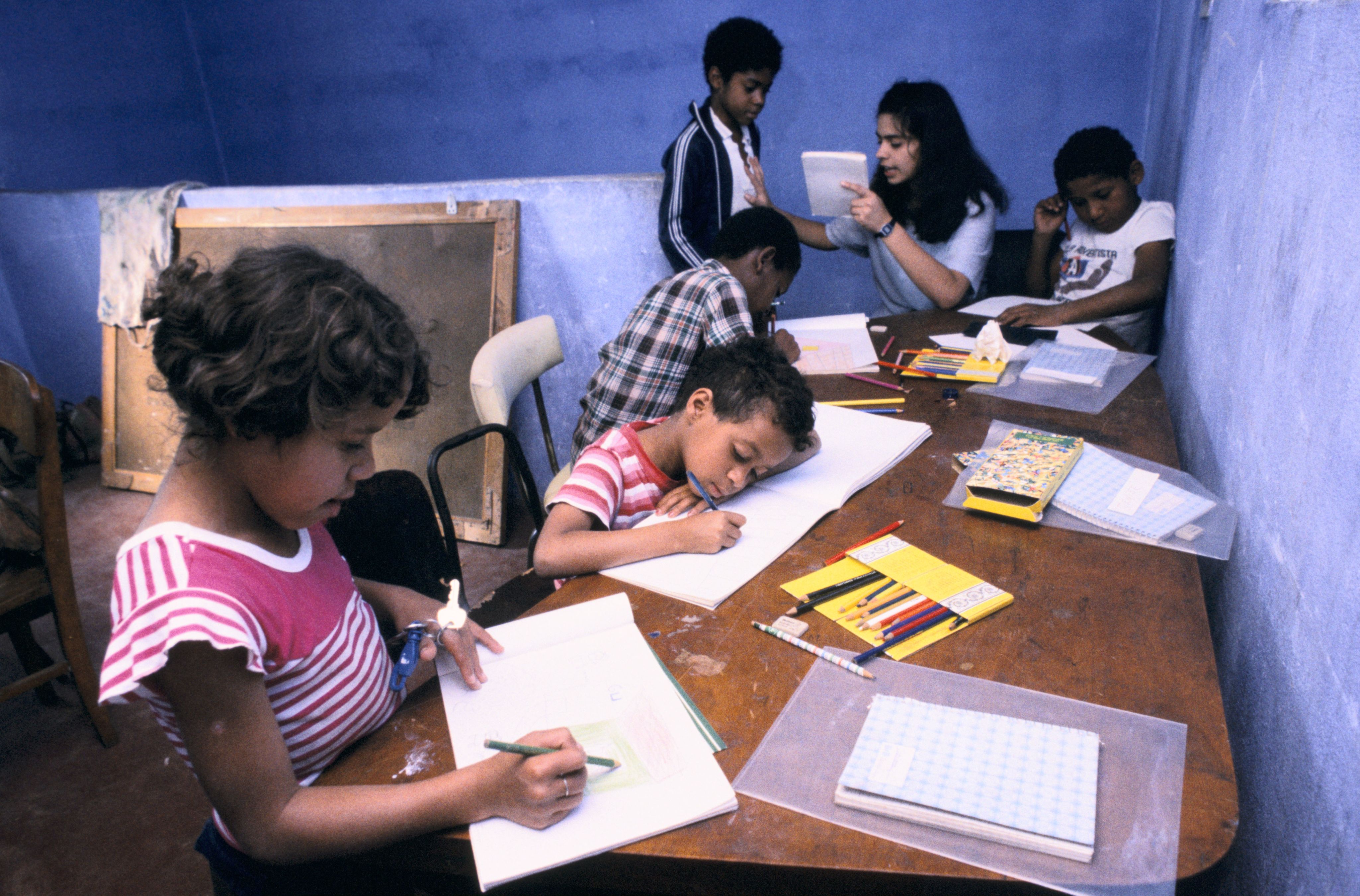 Children in classroom studying with teacher in India